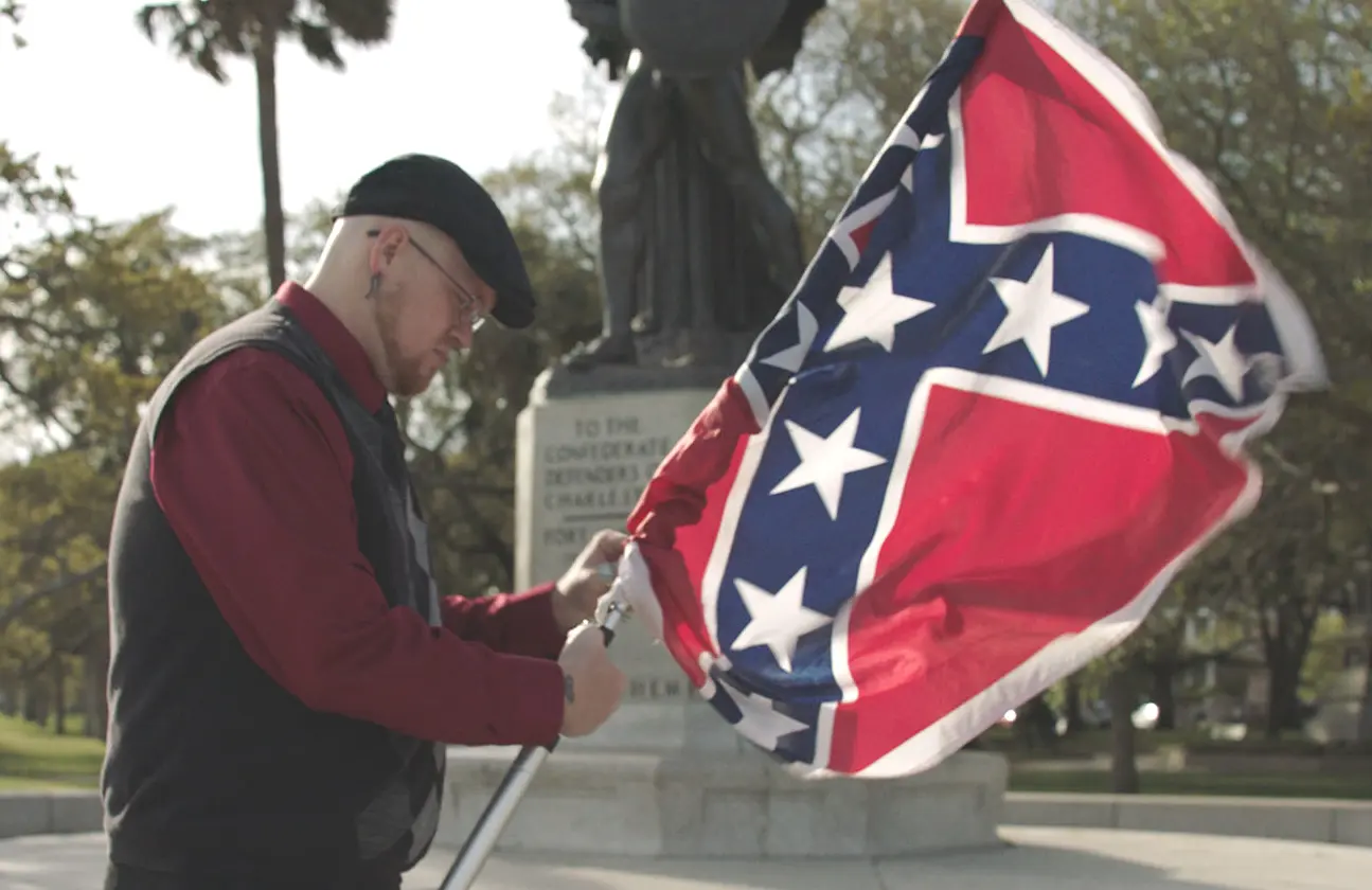 James Bessenger of the South Carolina Secessionist Party unfurls his Confederate Flag in Why We Hate. (Photo: Amblin Entertainment/Discovery)