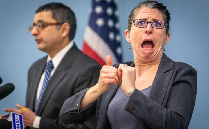 Certified deaf interpreter Regan Thibodeau works with Maine CDC Director Dr. Nirav Shah at a press conference in Augusta on Thursday. Thibodeau has emerged as a celebrity with her expressive interpretations of the daily coronavirus briefings. (ABIGAIL CURTIS / BANGOR DAILY NEWS)