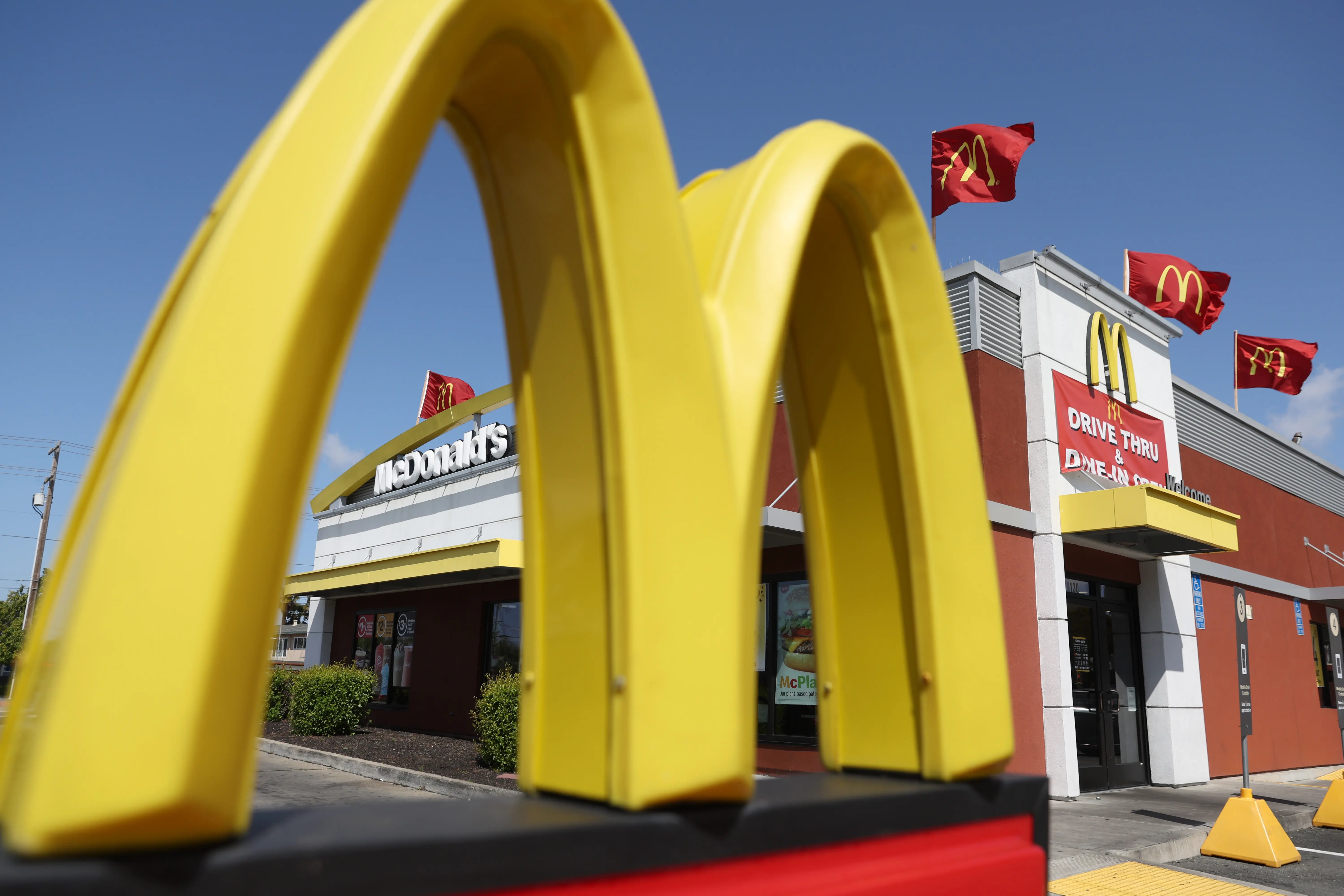 A sign is posted in front of a McDonald's restaurant (Image via Getty)
