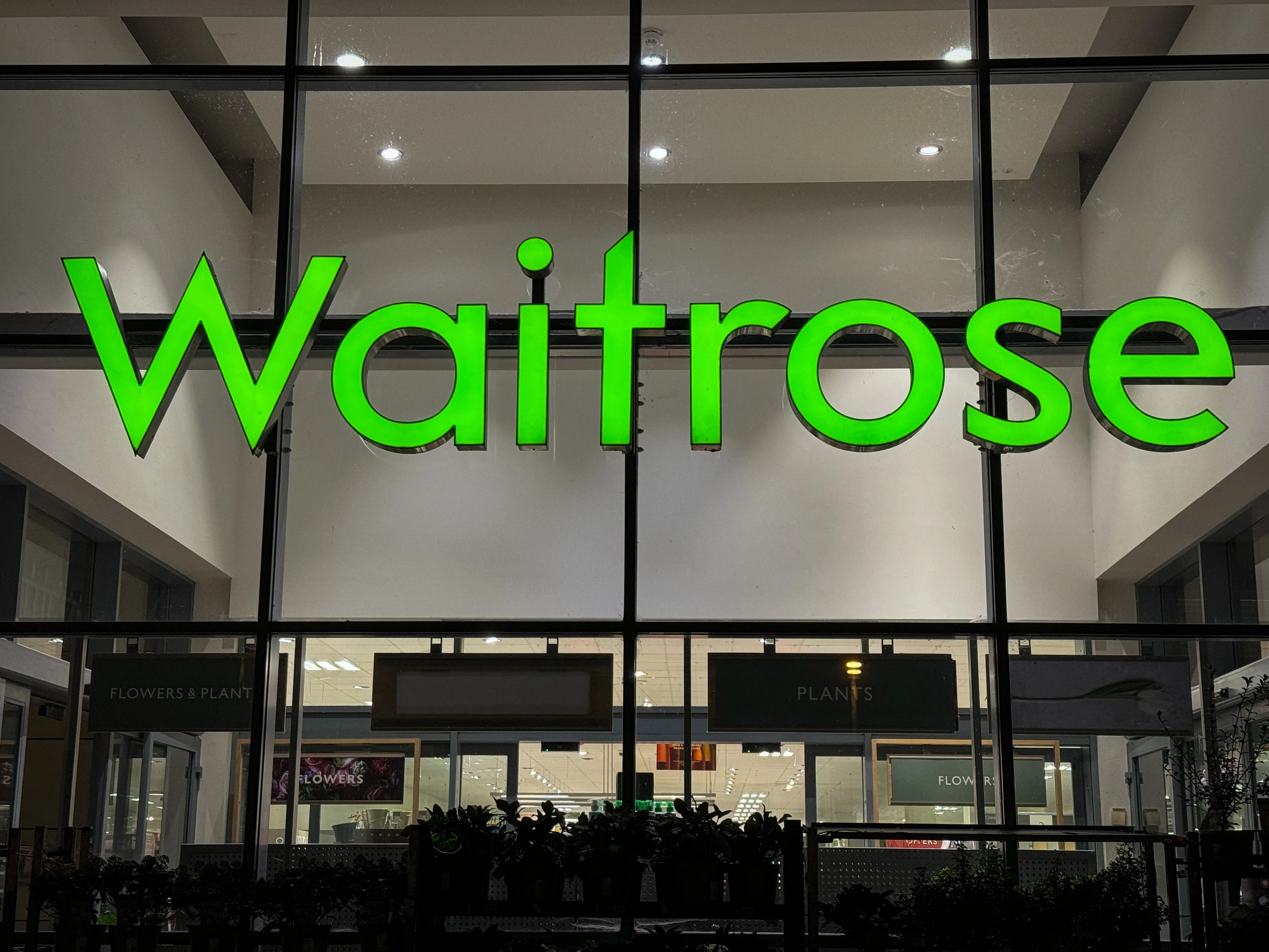 WELLS UNITED KINGDOM - NOVEMBER 05: The Waitrose logo is displayed outside a branch of the supermarket retailer Waitrose on November 5, 2023 in Wells, England. Founded in 1904, since 1937 it has been operated by employee-owned retailer John Lewis Partnership and is often described as having a upmarket reputation.