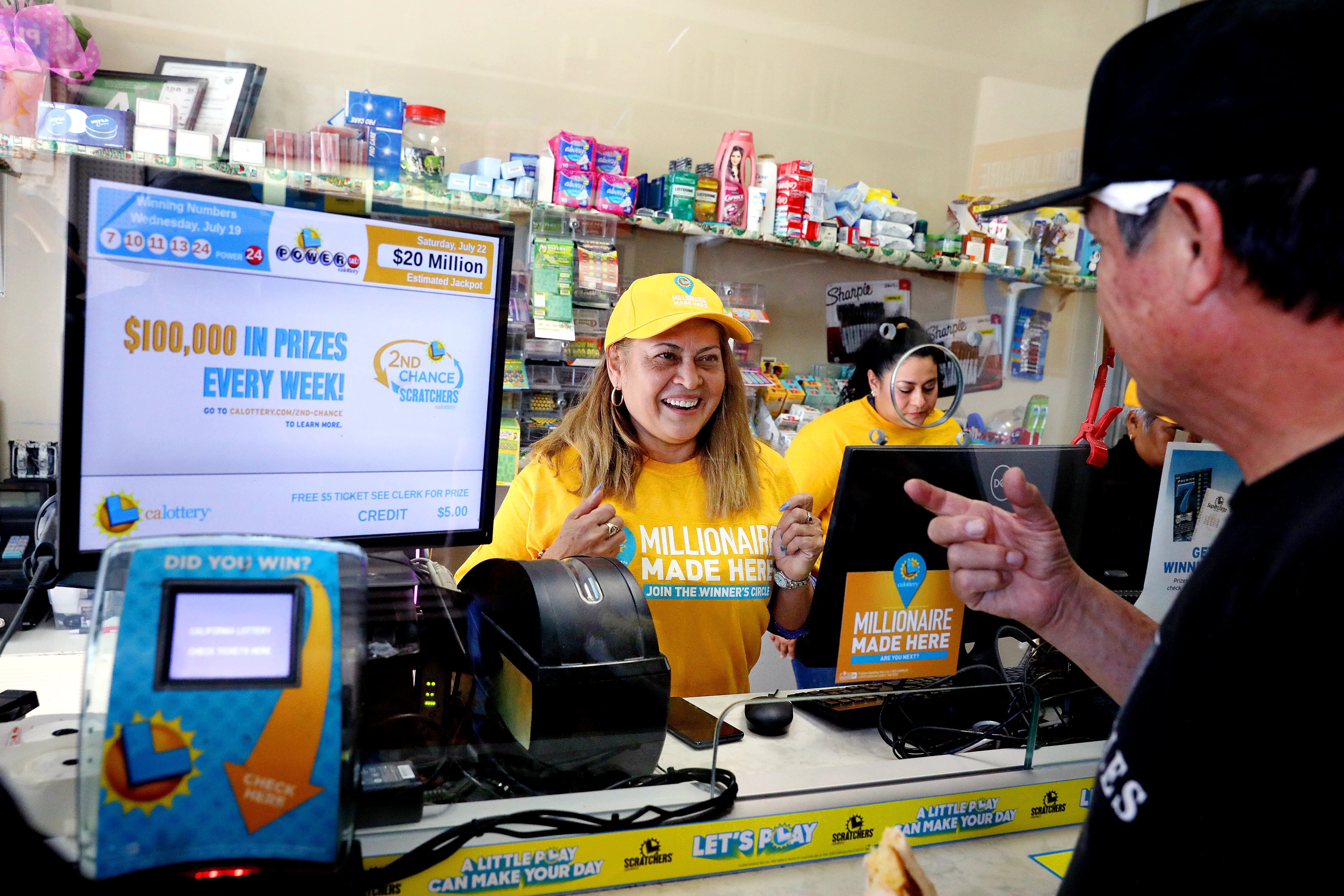 LOS ANGELES, CA - JULY 20: Maria Menjivar, owner, talks with a customer where a $1-billion Powerball ticket was sold at her store Las Palmitas Mini Market in downtown on Thursday, July 20, 2023 in Los Angeles, CA. The winner, who remains unidentified, purchased their ticket at Las Palmitas Mini Market at East 12th Street and Wall Street. (Gary Coronado / Los Angeles Times via Getty Images)
