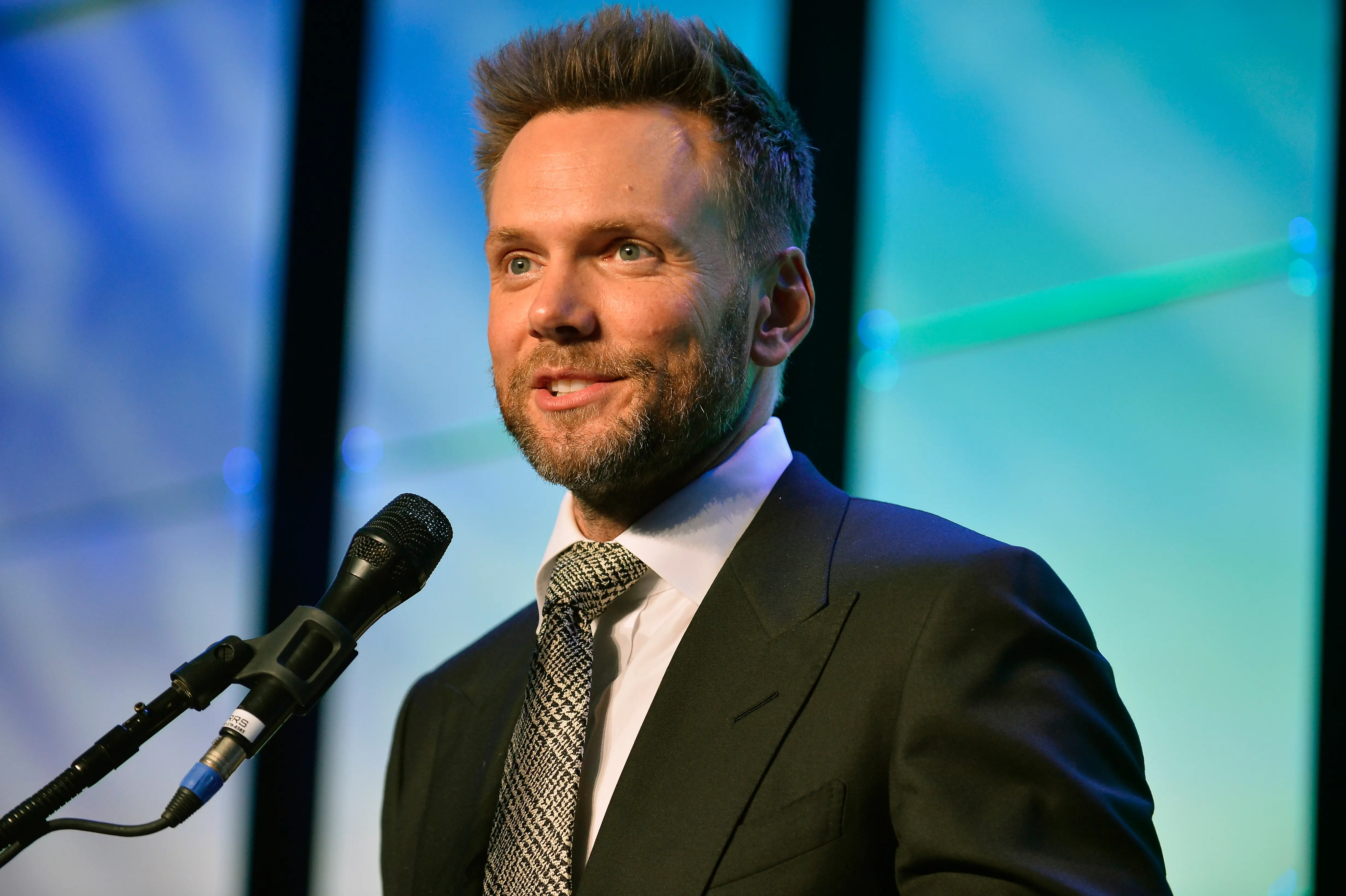 Actor/comedian Joel McHale speaking at an event.