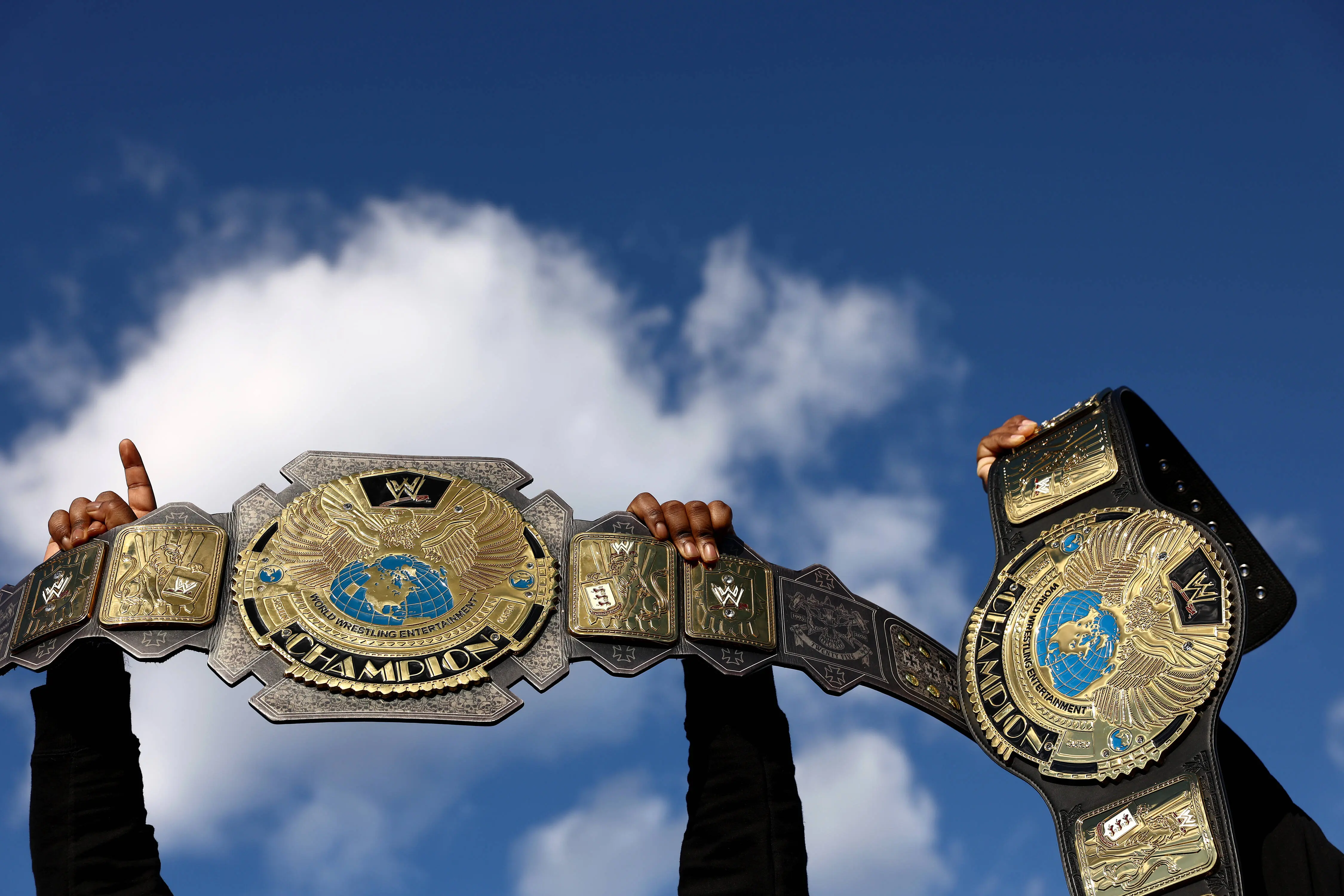 PHILADELPHIA, PENNSYLVANIA - APRIL 07: Fans displays their replica WWE Championship belts during Night Two outfield WrestleMania 40 at Lincoln Financial Field on April 07, 2024 in Philadelphia, Pennsylvania.  (Photo by Tim Nwachukwu/Getty Images)