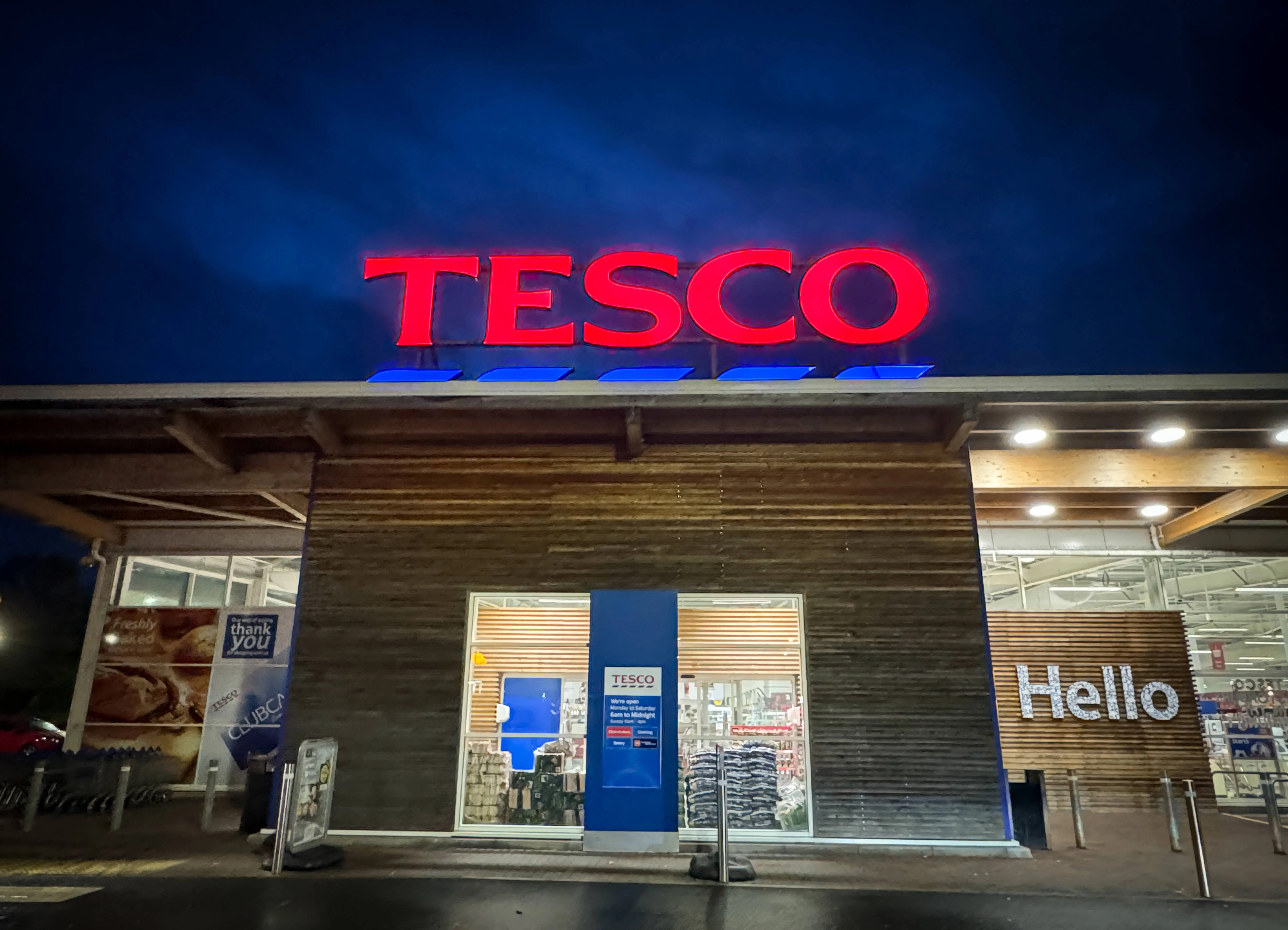 GLASTONBURY, UNITED KINGDOM - NOVEMBER 11: The Tesco logo is displayed outside a branch of the supermarket retailer Tesco on November 11, 2023 in Glastonbury, England. The British retailer, founded in 1919, is one of the largest in the world and is the market leader of groceries in the UK.