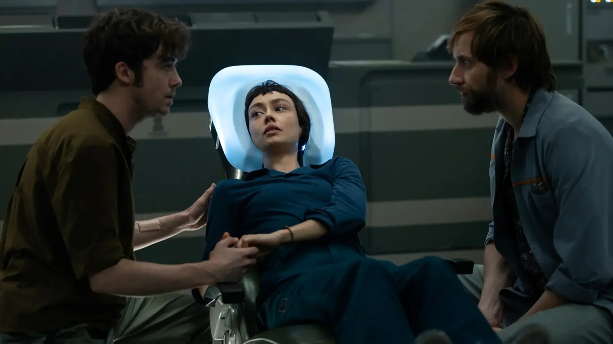 Alien: Earth Episode 4, Observation: Wendy (Sydney Chandler) is stabilized in Prodigy’s med bay as Hermit (Alex Lawther) and Arthur (David Rysdahl) look on. Image courtsey: FX and Hulu.