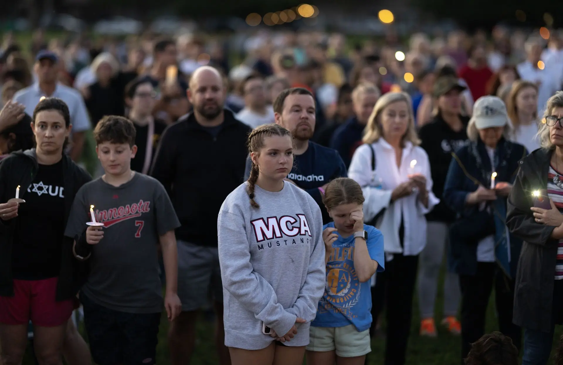 People attend a vigil at Lynnhurst Park to mourn the dead and pray for the wounded after a gunman opened fire on students at Annunciation Catholic School on August 27, 2025 in Minneapolis, Minnesota (Image via Getty)