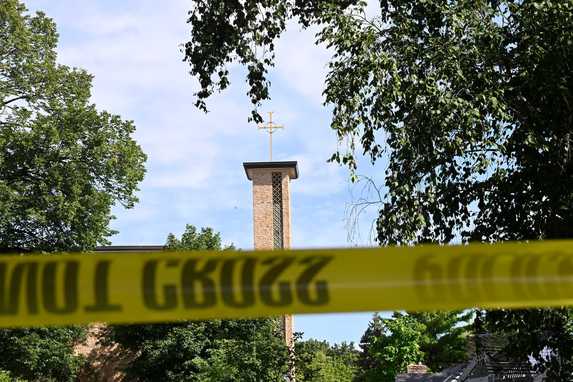 The Annunciation Catholic Church is seen behind police tape following a mass shooting on August 27, 2025 in Minneapolis, Minnesota (Image via Getty)