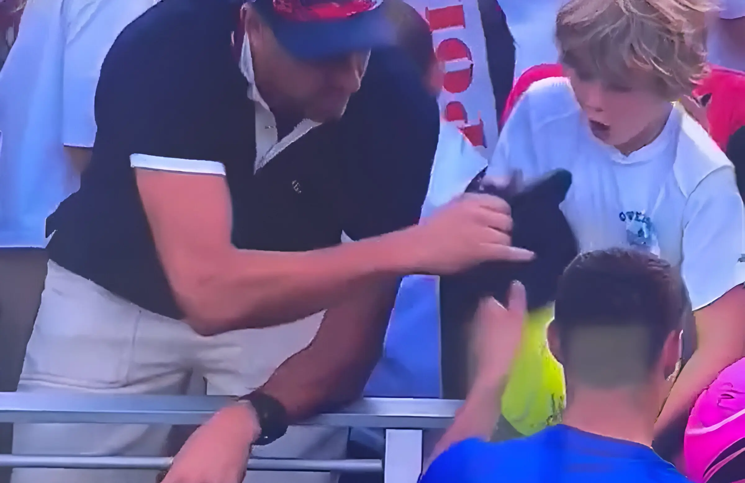 A man stole Kamil Majchrzak's hat from a kid's hands. (Photo: X/@Bubblebathgirl)