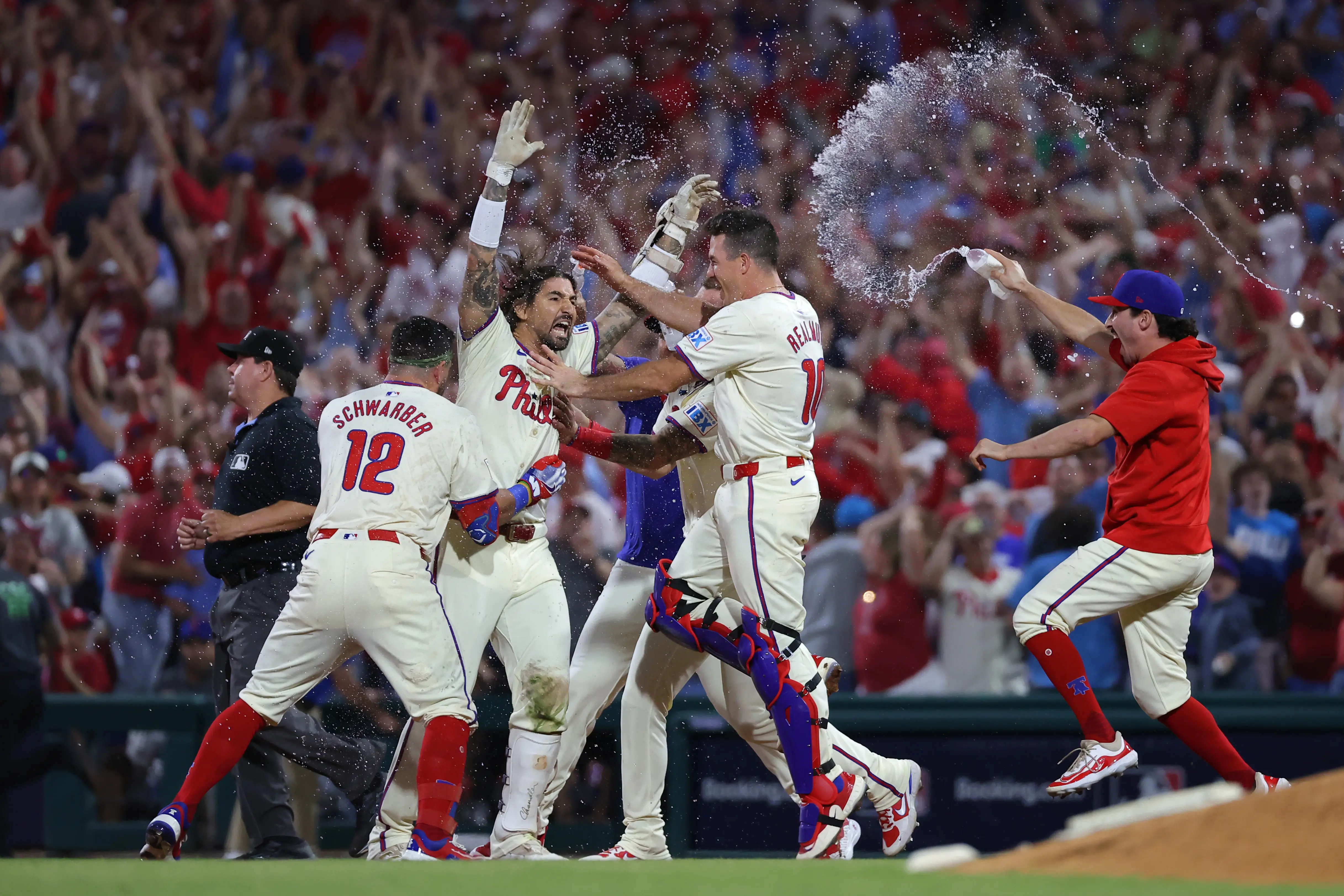 Philadelphia Phillies celebrate after the game-winning hit to defeat the New York Mets in Game Two of the Division Series at Citizens Bank Park on October 06, 2024 in Philadelphia, Pennsylvania. (Photo by Hunter Martin/Getty Images)
