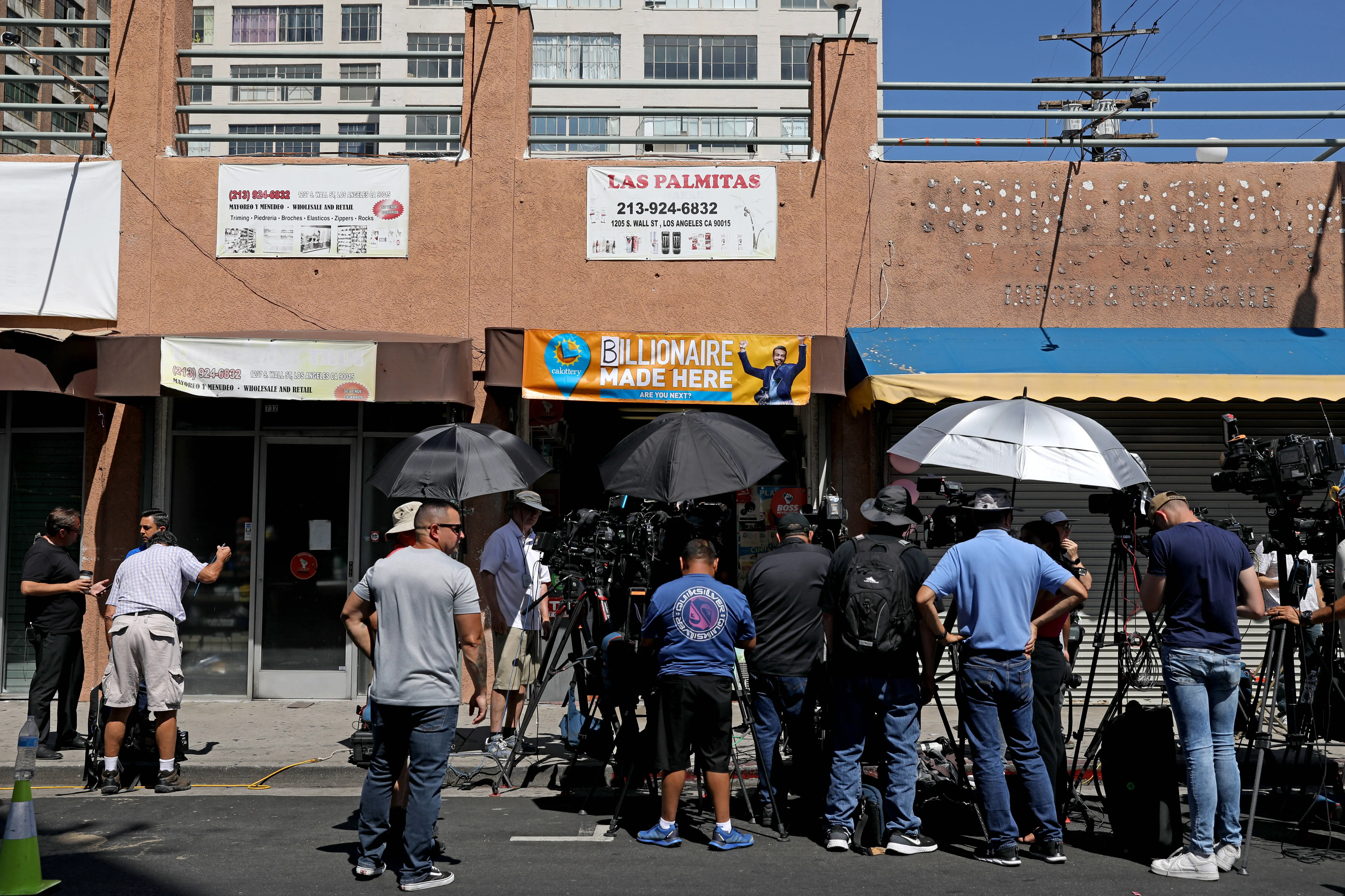 LOS ANGELES, CA - JULY 20: The media gathers where a $1-billion Powerball ticket was sold at Las Palmitas Mini Market in downtown on Thursday, July 20, 2023 in Los Angeles, CA. The winner, who remains unidentified, purchased their ticket at Las Palmitas Mini Market at East 12th Street and Wall Street. (Gary Coronado / Los Angeles Times via Getty Images)
