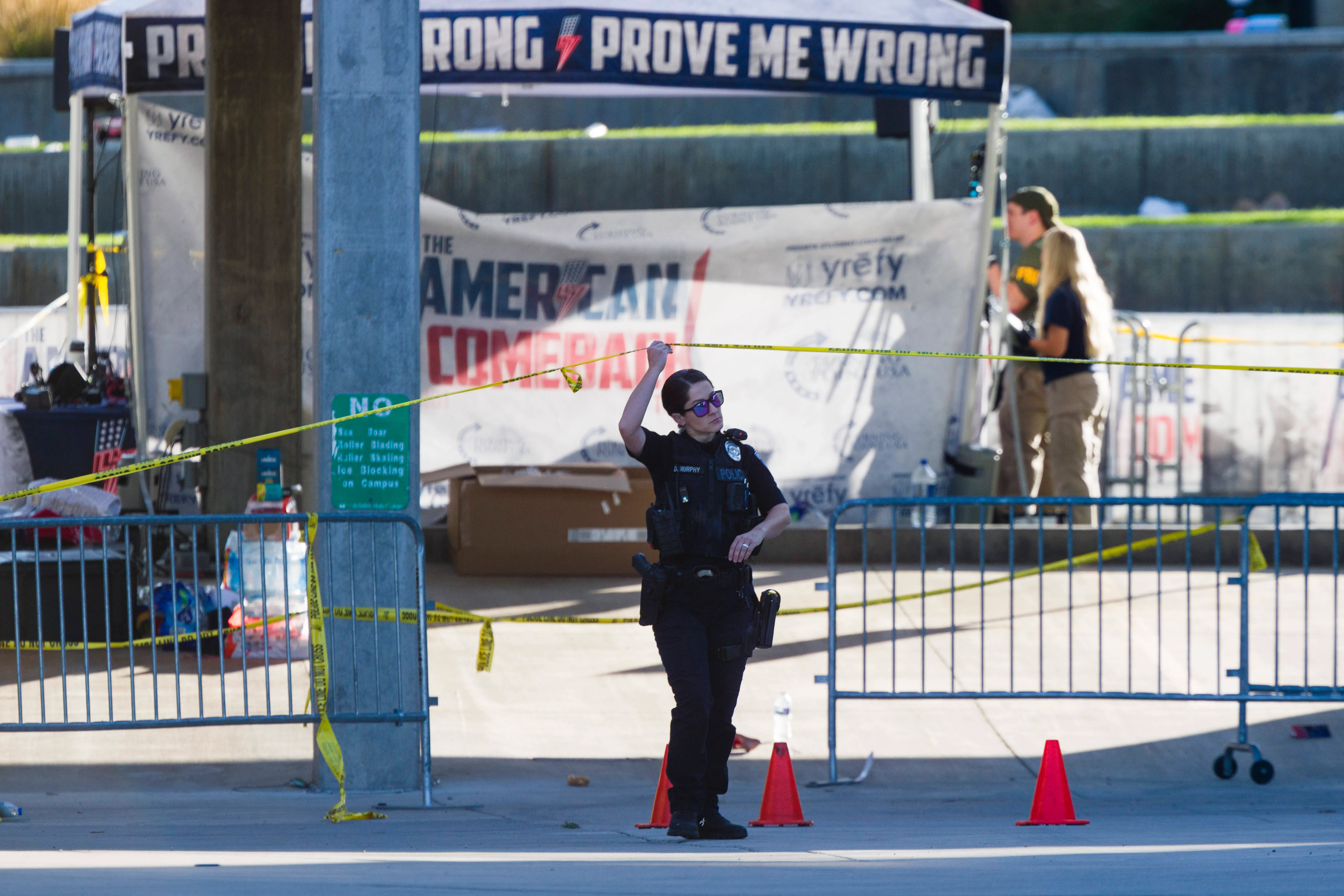 OREM, UTAH - SEPTEMBER 11: Police officers and FBI agents walk through the courtyard at Utah Valley University as authorities search for the man who killed political activist Charlie Kirk on September 11, 2025 in Orem, Utah. Kirk, founder of Turning Point USA, was speaking at his "American Comeback Tour" when he was shot in the neck and killed. (Photo by Michael Ciaglo/Getty Images)
