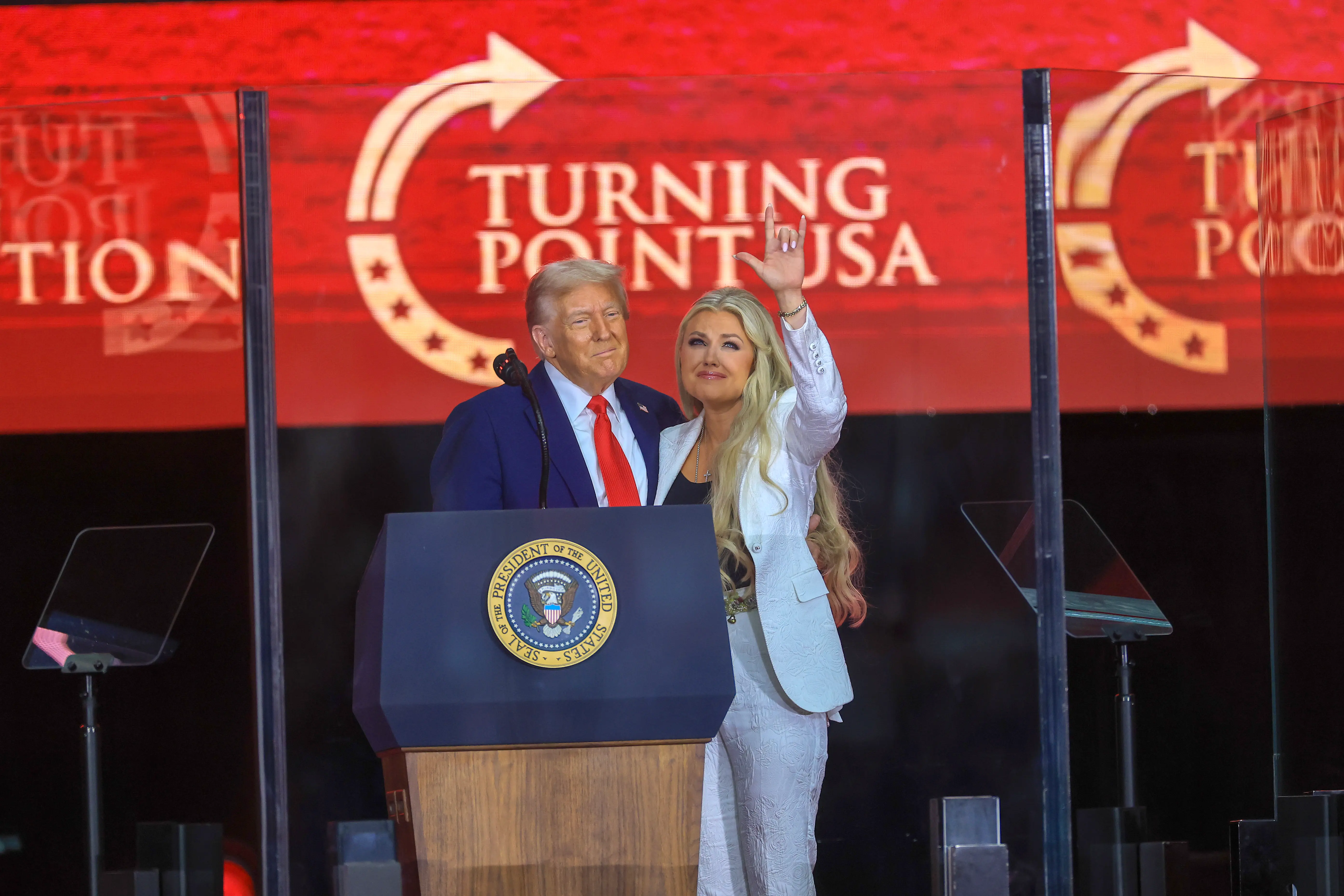 Erika Kirk joins U.S. President Donald Trump onstage during the memorial service for political activist Charlie Kirk at State Farm Stadium on September 21, 2025 in Glendale, Arizona. Kirk, the CEO and co-founder of Turning Point USA, was shot and killed on September 10th while speaking at an event during his "American Comeback Tour" at Utah Valley University. (Photo by Joe Raedle/Getty Images)