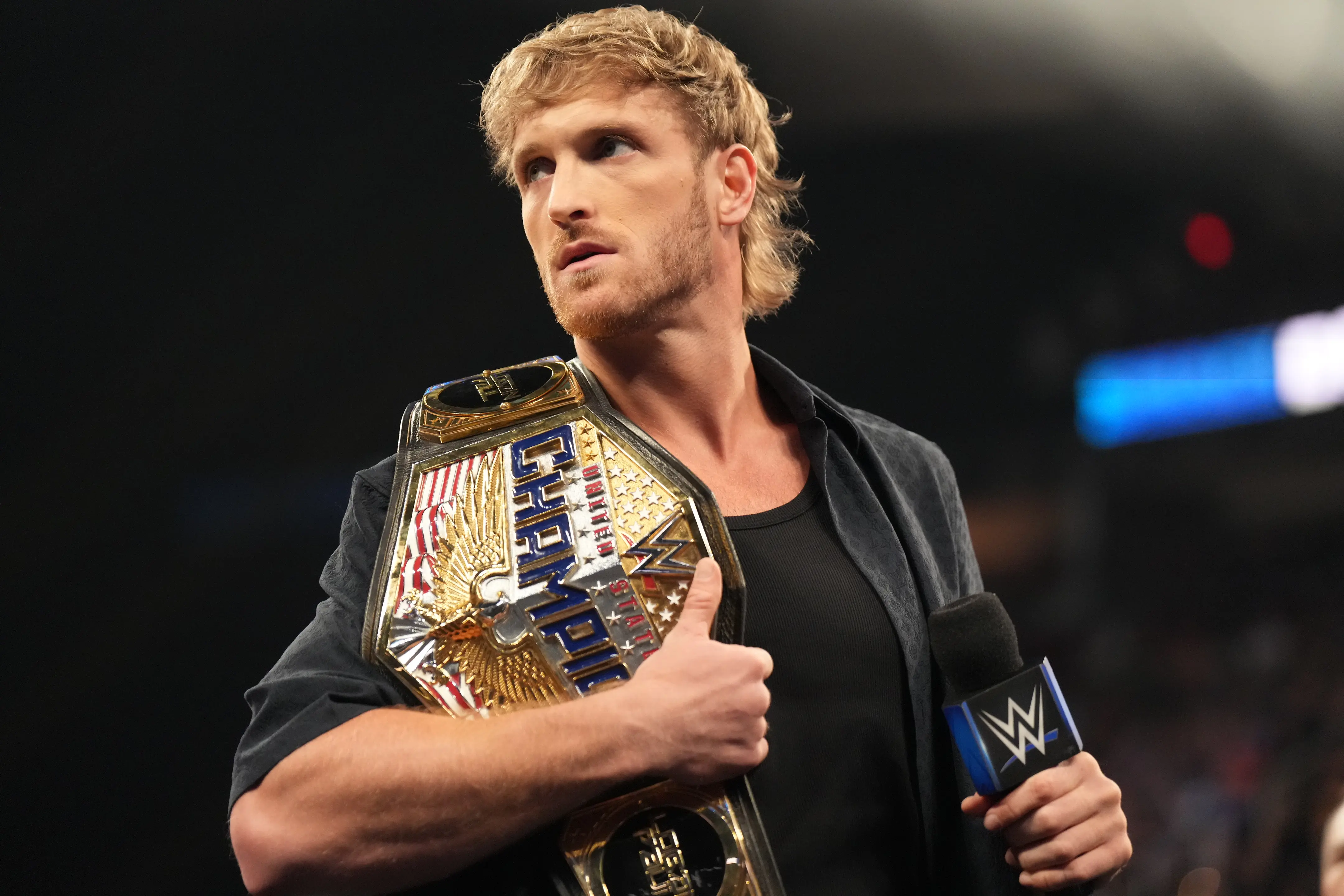 CLEVELAND, OHIO - AUGUST 2: United States Champion Logan Paul addresses the crowd during SmackDown at Rocket Mortgage FieldHouse on August 2, 2024 in Cleveland, Ohio.  (Photo by WWE/Getty Images)