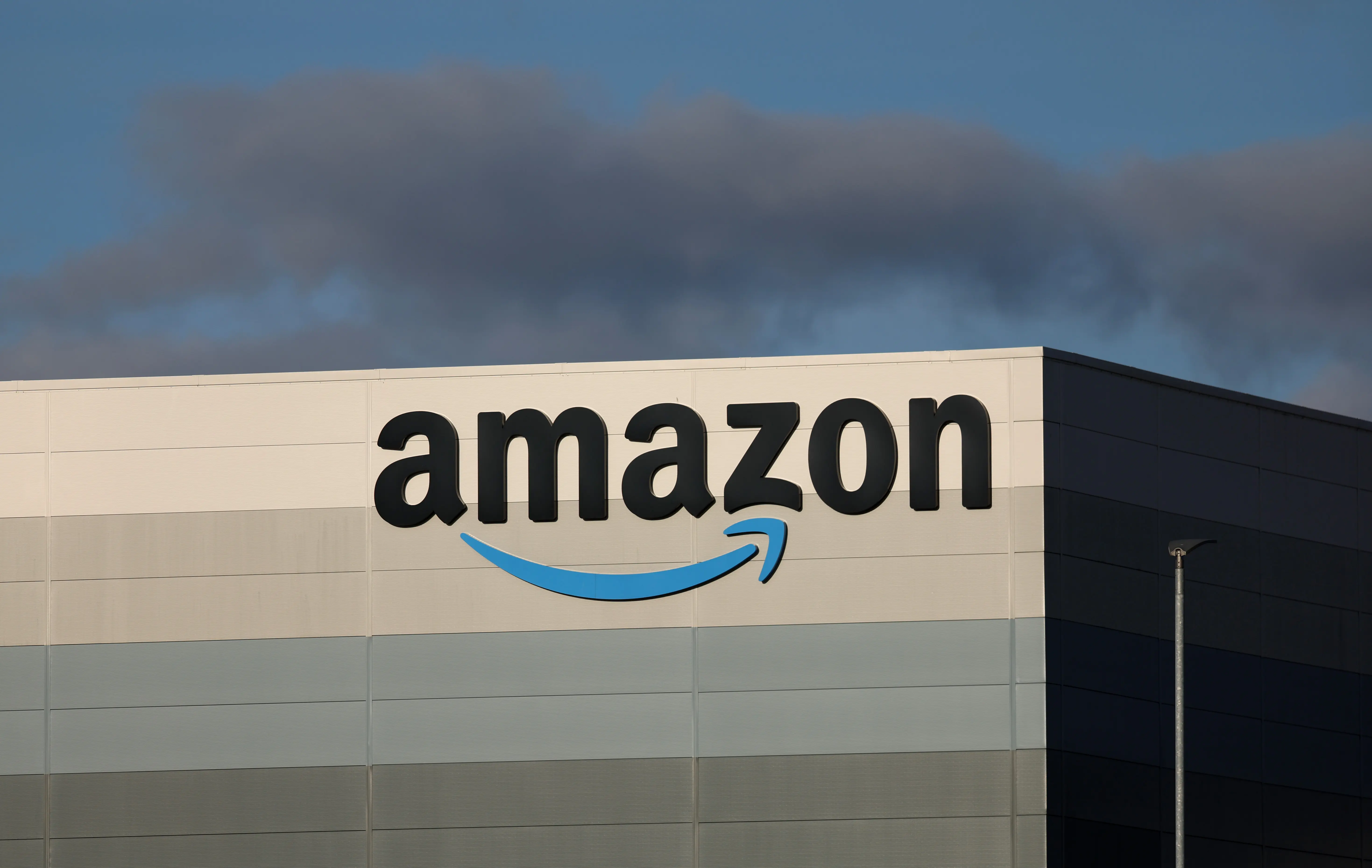 HAYDOCK, ENGLAND - OCTOBER 15: The Amazon logo is displayed outside Amazon UK MAN8 Warehouse on October 15, 2023 in Haydock, United Kingdom. (Photo by Nathan Stirk/Getty Images)