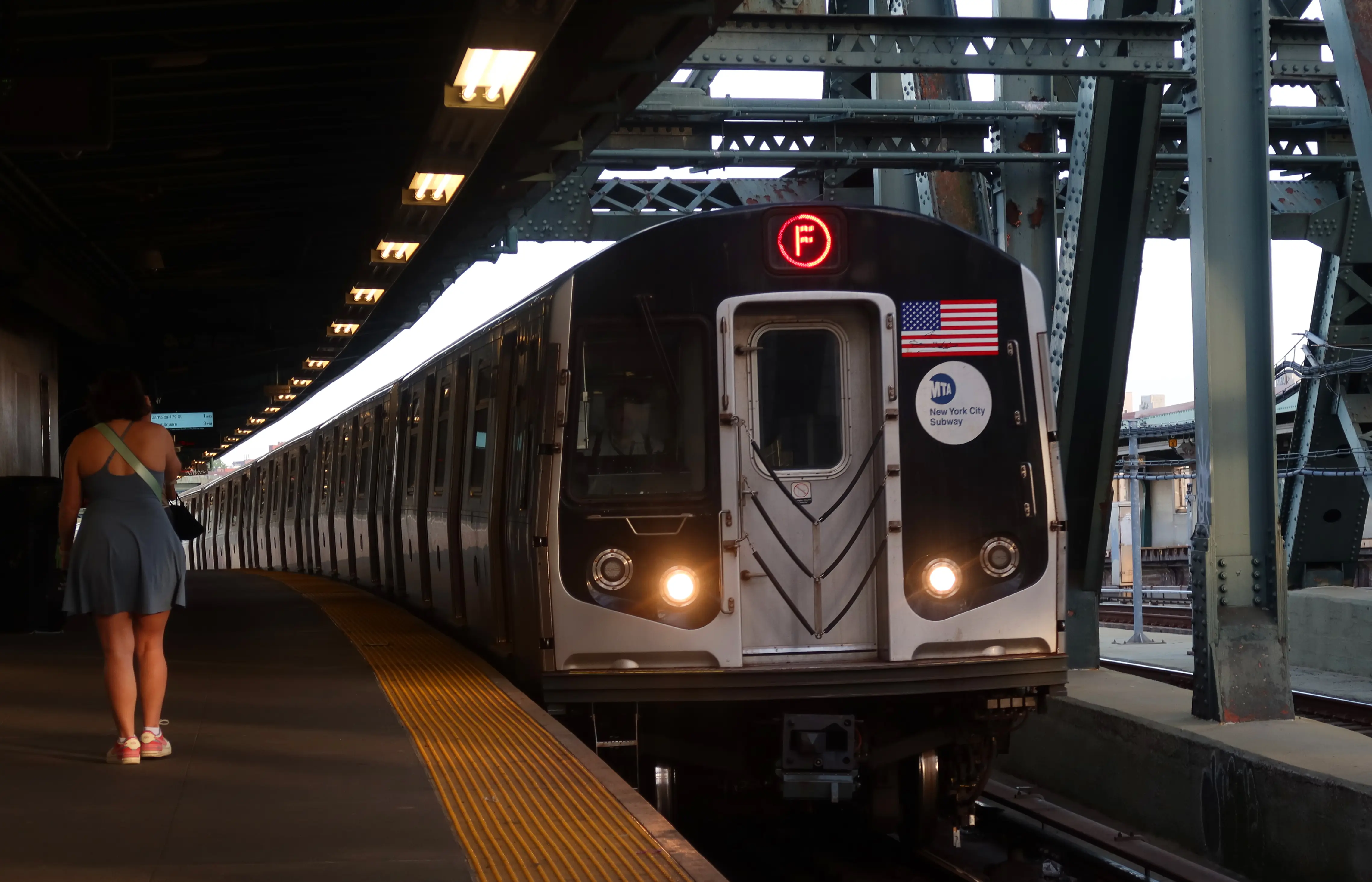 A woman waits to board an F train at the Smith - 9th Street subway station on May 7, 2024, in New York City.  (Photo by Gary Hershorn/Getty Images)