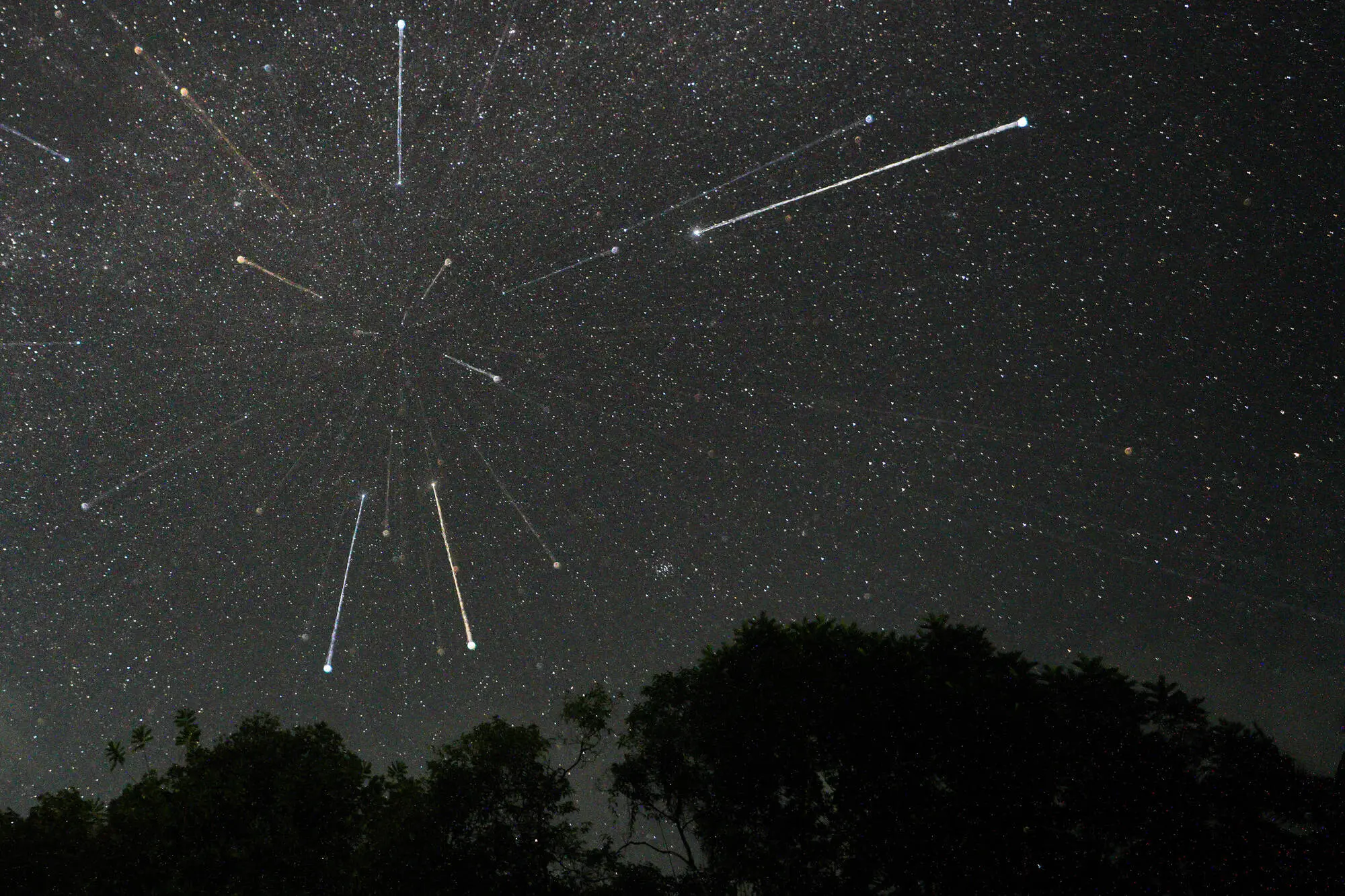 Stars are being seen in the sky during the Geminid meteor showers in Ratnapura, Sri Lanka, on December 14, 2023. The Geminids are a prolific meteor shower caused by the object 3200 Phaethon, which is thought to be a Palladian asteroid with a ''rock comet'' orbit. This makes the Geminids, together with the Quadrantids, the only major meteor showers not originating from a comet. (Photo by Thilina Kaluthotage/NurPhoto via Getty Images)