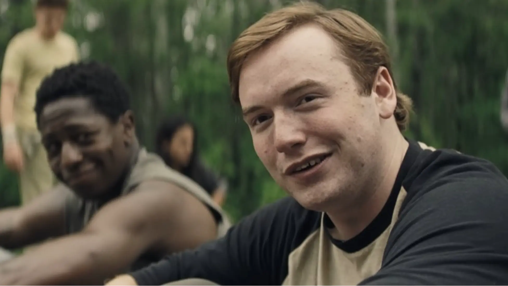 Walkers share a rare roadside breather in The Long Walk. Credit: YouTube/@Lionsgate Movies.