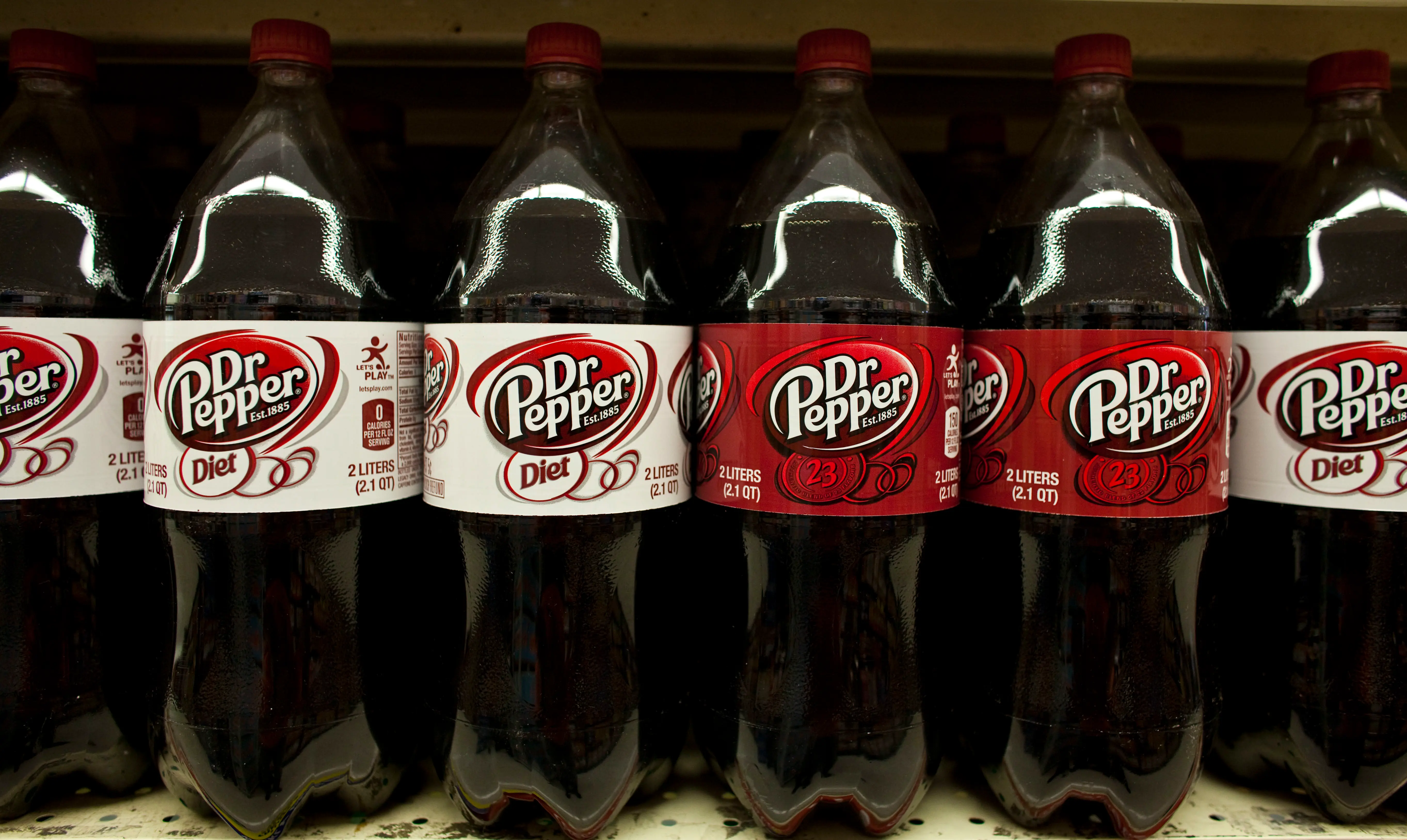 Bottles of diet Dr Pepper and regular Dr Pepper soft drinks are displayed at a supermarket in the Brooklyn borough of New York, on Tuesday, July 26, 2011. The US annual soft drinks sales is approximately $66 billion. Coca-Cola Co., PepsiCo Inc., and Cadbury Schweppes Plc, control over 91% of the U.S. market share. (Photo by Ramin Talaie/Corbis via Getty Images)