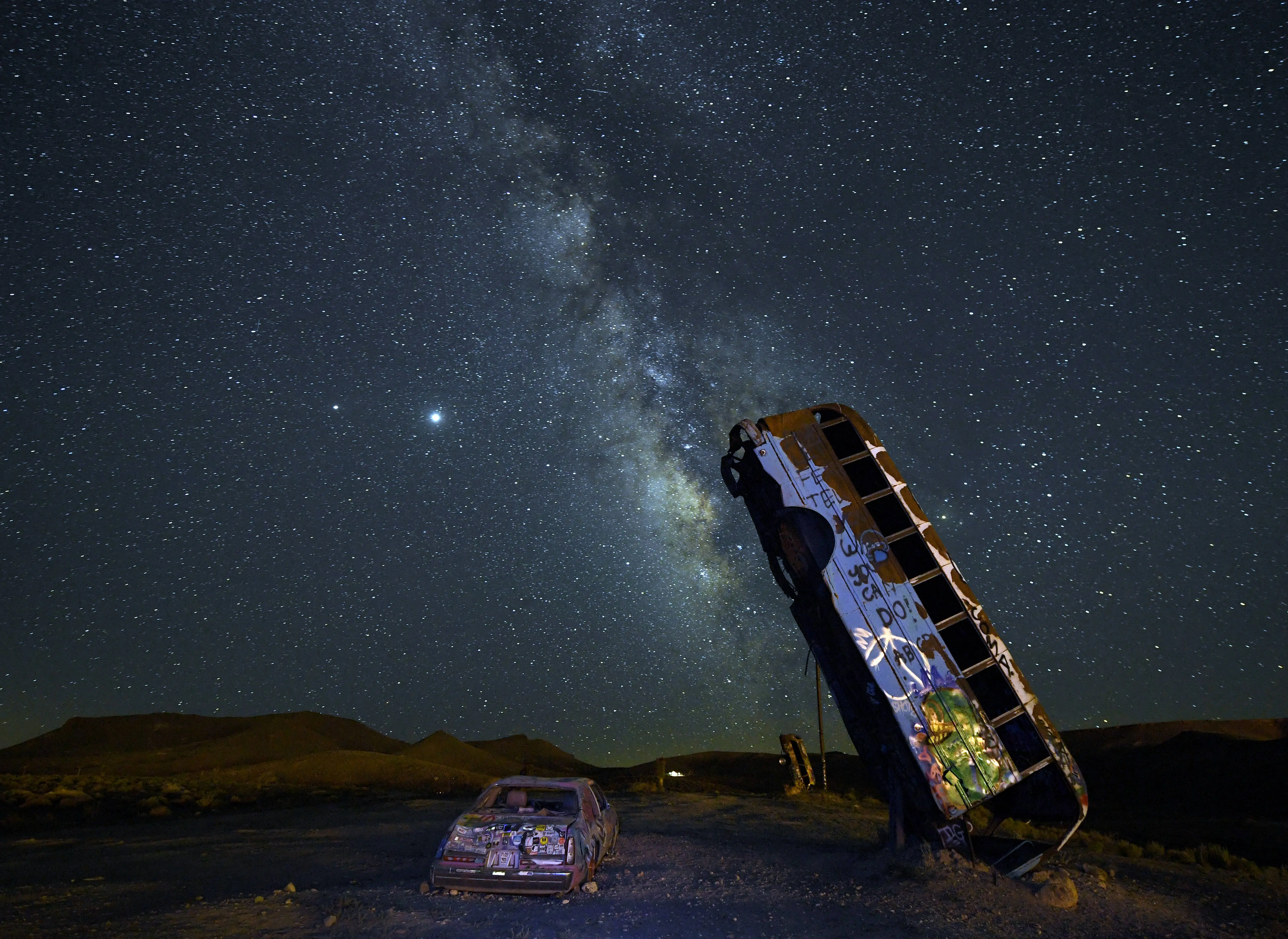 GOLDFIELD, NEVADA - JULY 18:  The Milky Way galaxy is seen from the International Car Forest of the Last Church on July 19, 2020 in Goldfield, Nevada. The Car Forest is an outdoor art installation of junk vehicles planted in the ground vertically.  (Photo by Ethan Miller/Getty Images)