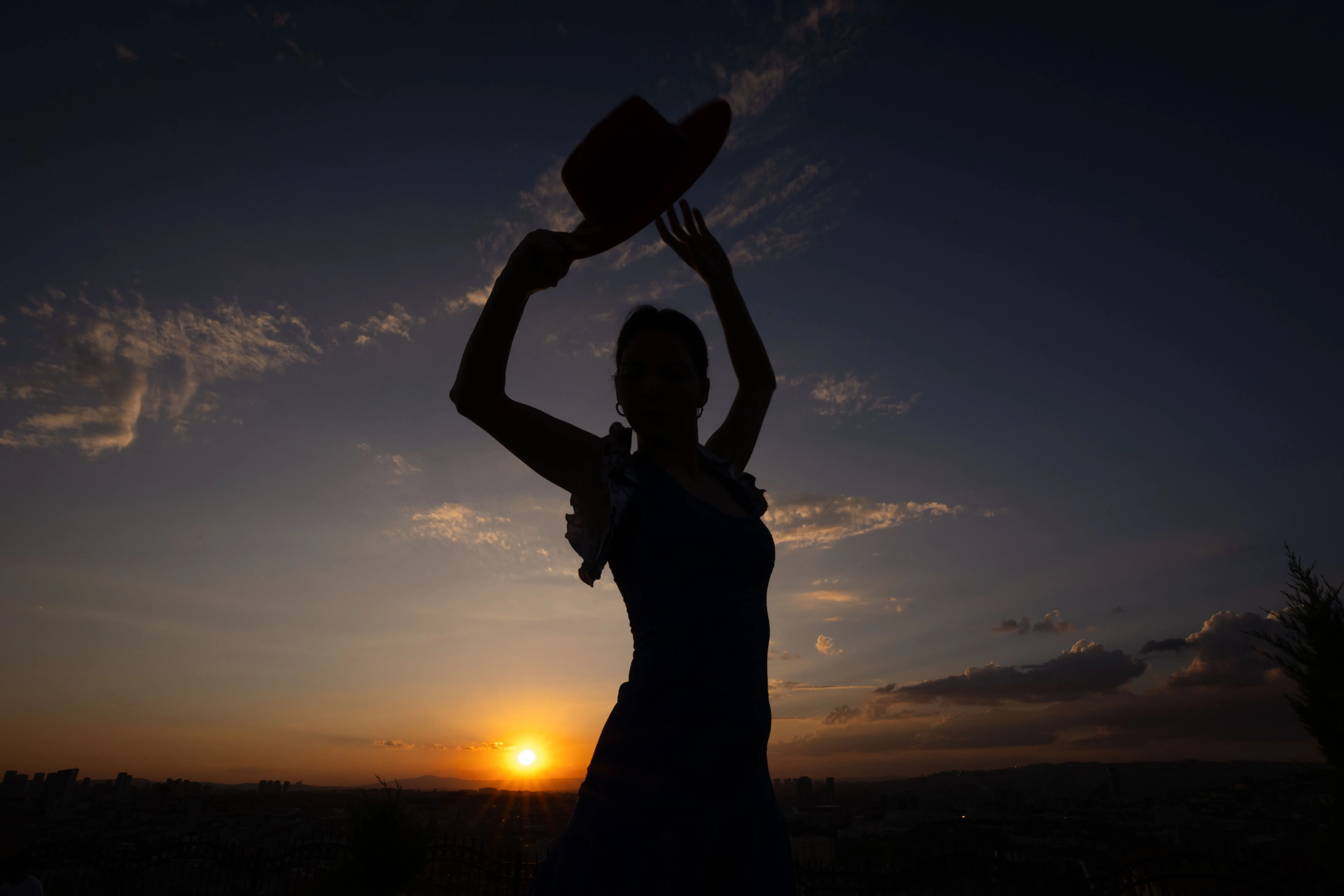 ANKARA, TURKIYE - AUGUST 28: A view of the silhouette of a flamenco dancer dancing in front of the reddish sky during sunset at 50th Anniversary Park in Ankara, Turkiye on August 28, 2024. (Photo by Betul Abali /Anadolu via Getty Images)