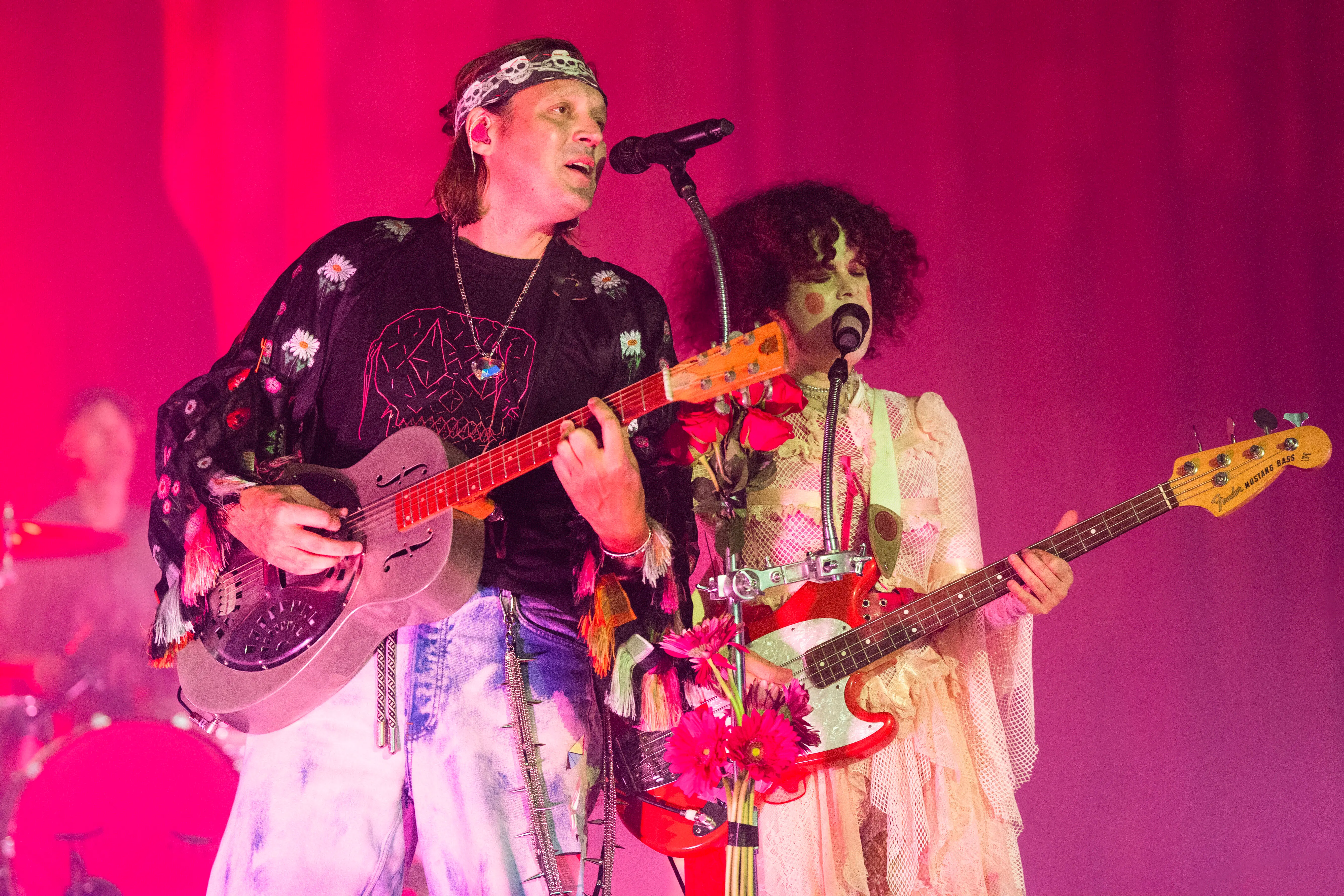 Win Butler and Regine Chassagne of Arcade Fire perform during the Don't Think About The Pink Elephant Tour at Saenger Theatre (Image via Getty)