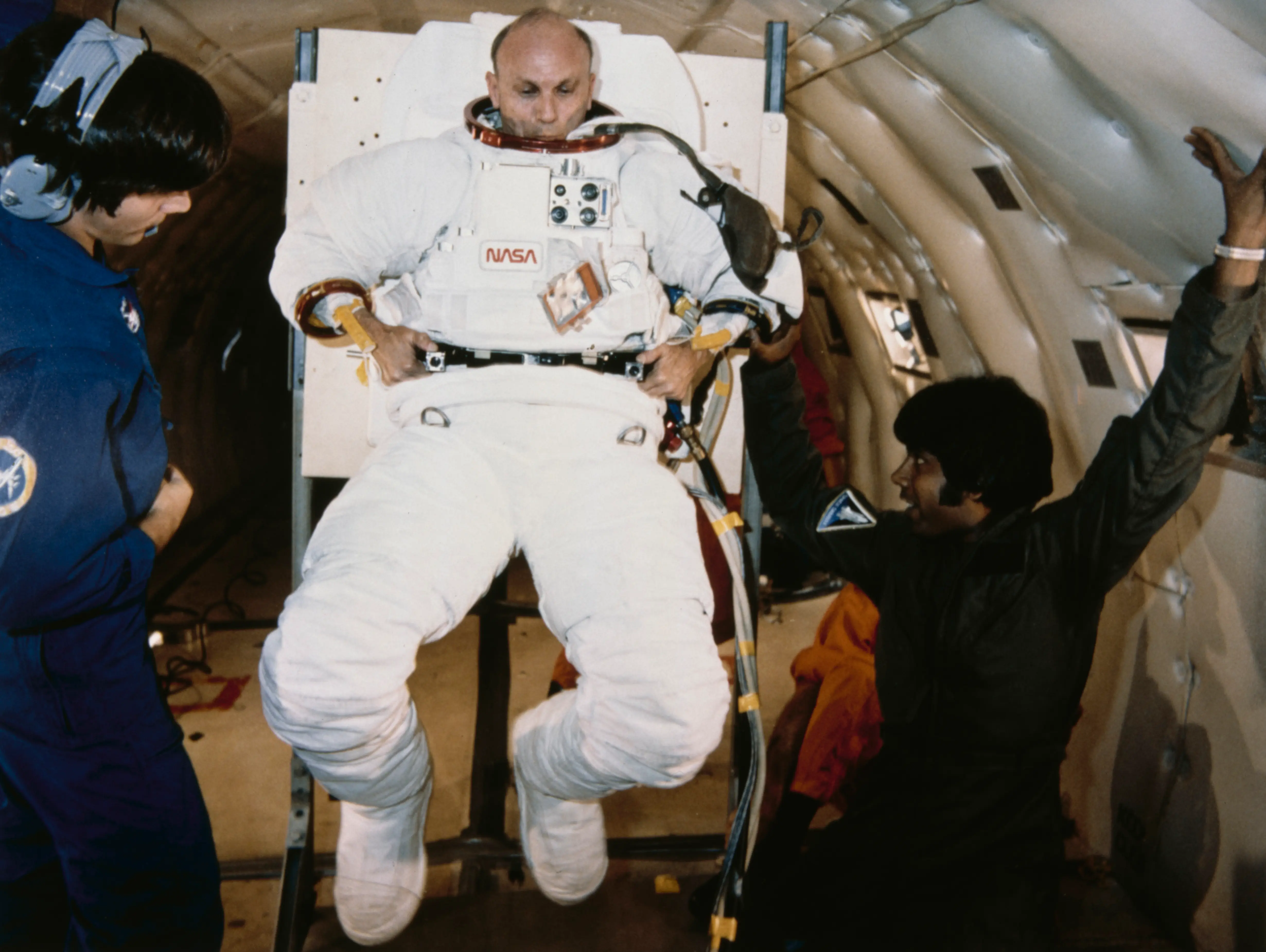 American astronaut Thomas Kenneth Mattingly II, Commander of the STS-4 NASA Space Shuttle mission on the shuttle Columbia, learns to put on and take off his spacesuit on board a Boeing KC-135 Stratotanker zero-gravity simulator aircraft (known as the 'Vomit Comet'), 22nd July 1981. Mattingly is wearing an extravehicular mobility unit (EMU) minus gloves and helmet.    (Photo by Space Frontiers/Archive Photos/Getty Images)