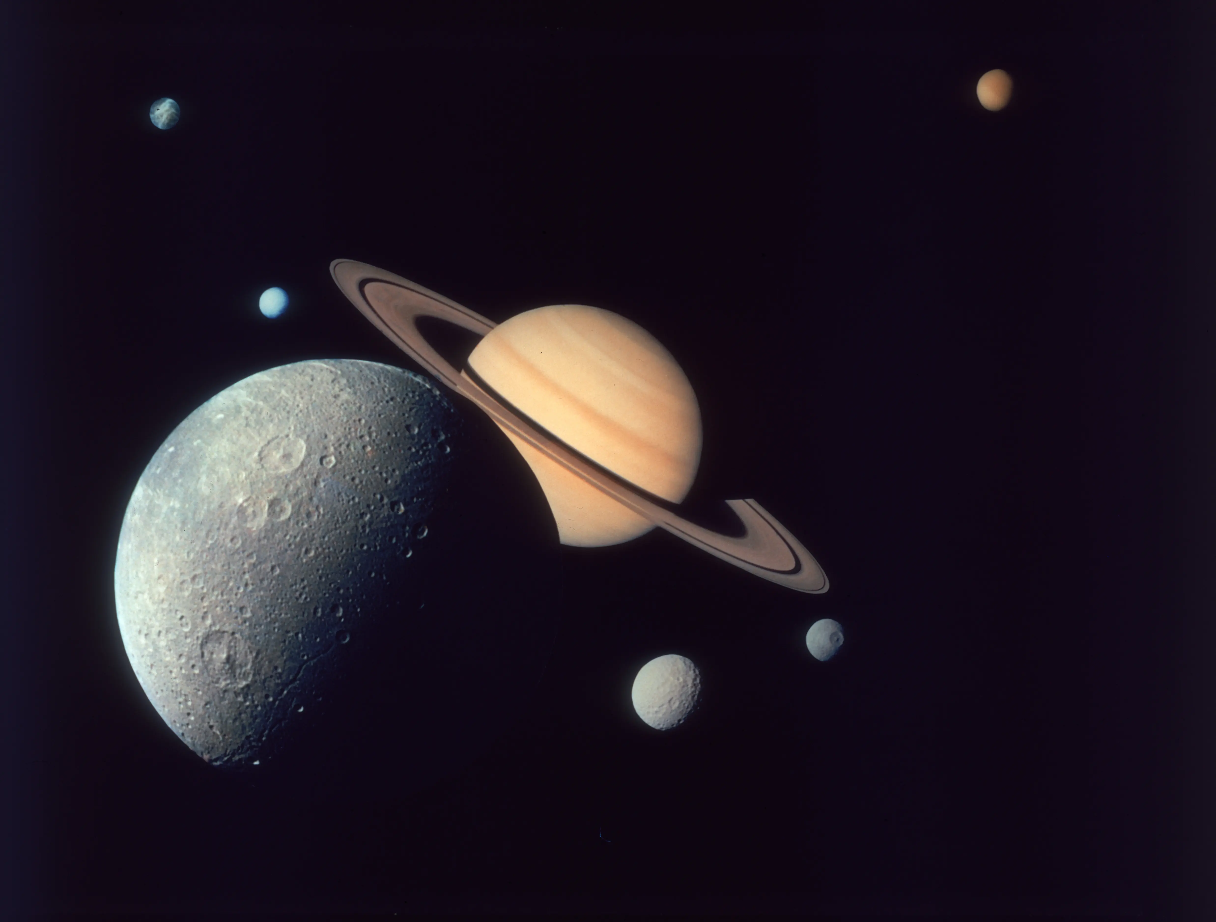 A montage of Saturn and its moons Dione (front), Tethys and Mimas (right), Enceladus and Rhea (left), and Titan (distant top), as depicted by the Voyager 1 spacecraft, November 1980. (Photo by Space Frontiers/Hulton Archive/Getty Images)