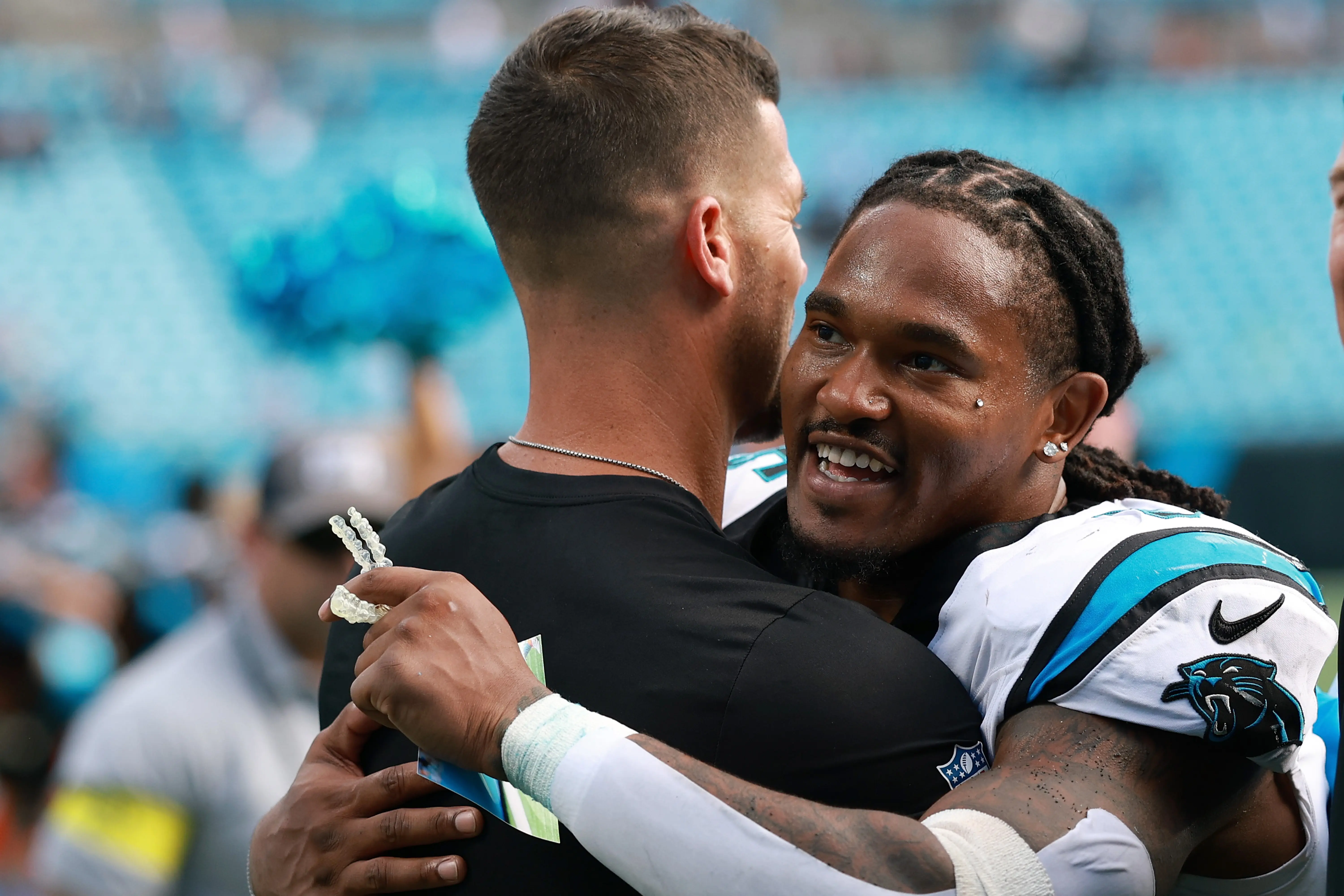 CHARLOTTE, NORTH CAROLINA - OCTOBER 05: Head coach Dave Canales and Rico Dowdle #5 of the Carolina Panthers hug after the 27-24 win against the Miami Dolphins in the game at Bank of America Stadium on October 05, 2025 in Charlotte, North Carolina. (Photo by Grant Halverson/Getty Images)