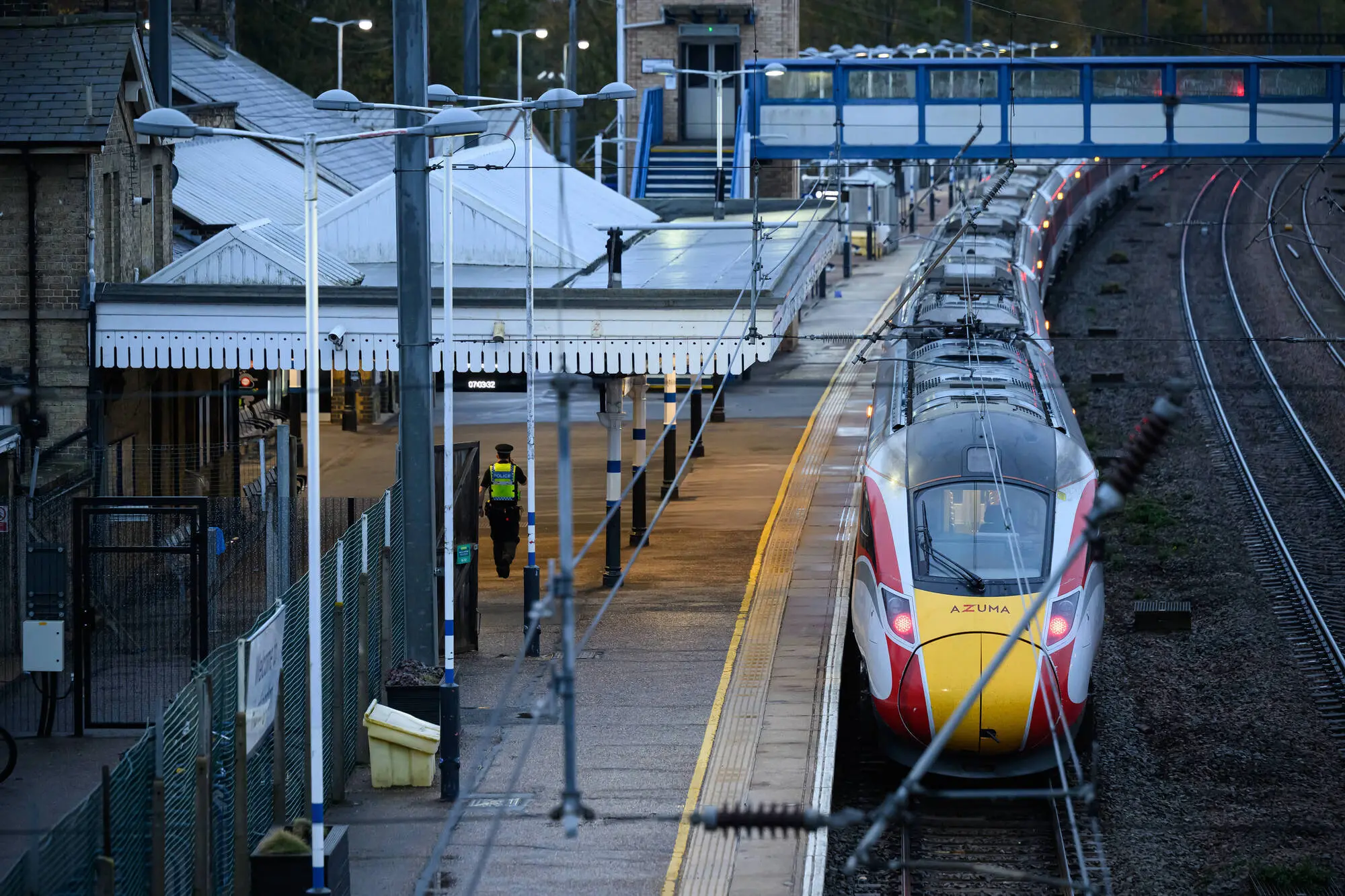 HUNTINGDON, ENGLAND - NOVEMBER 02: A Police officer walks on the platform as emergnecy services attend to Huntingdon Station on November 02, 2025 in Huntingdon, England after a stabbing attack on a train. Yesterday evening, multiple people were injured in a knife attack on the 18:25 LNER service from Doncaster to London King's Cross, forcing the train to make an emergency stop in Huntingdon. Police said two people were arrested and the injured were taken to hospital. (Photo by Leon Neal/Getty Images)