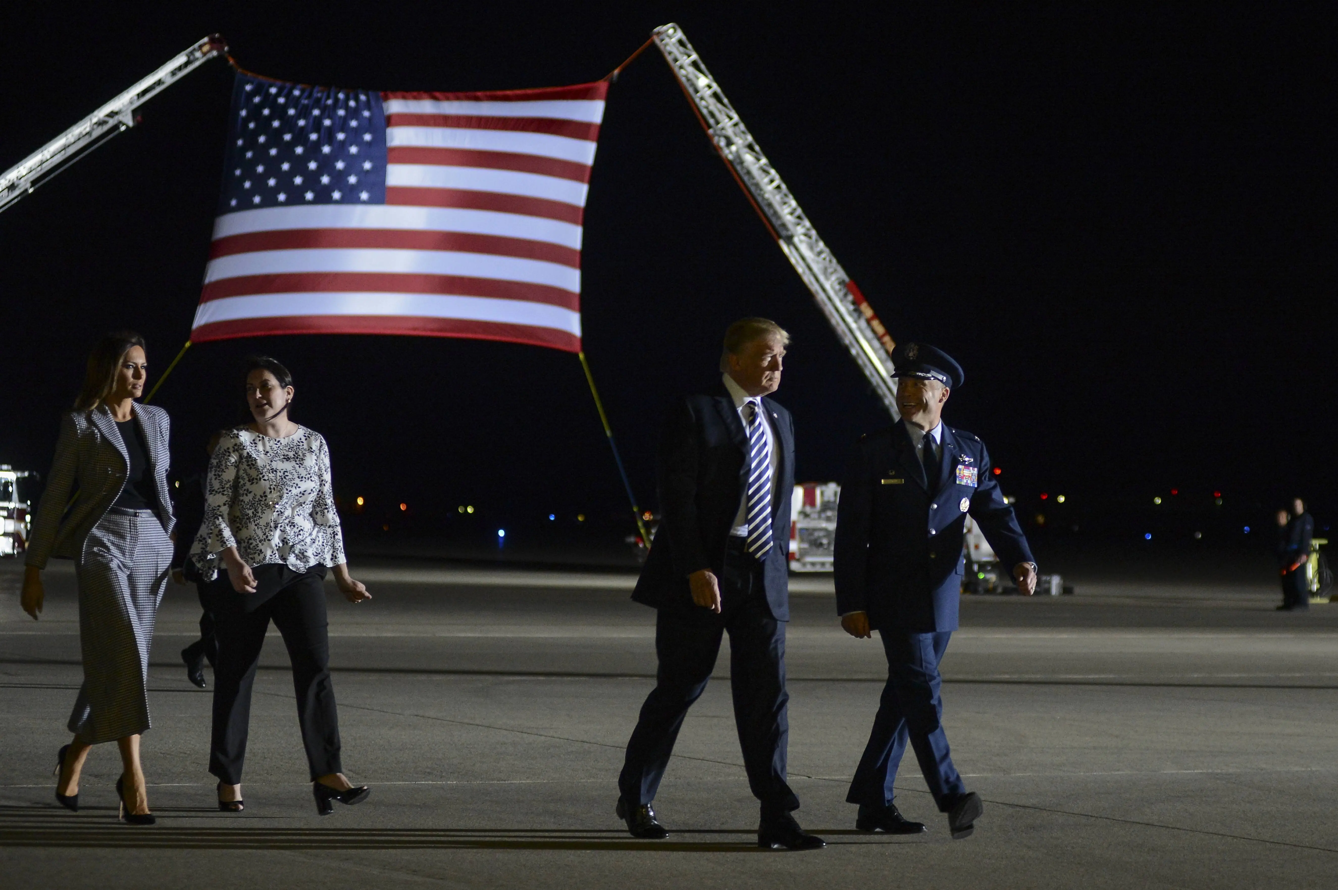 President of the United States Donald J Trump and First Lady Melania Trump walking with Col Casey D Eaton, 89th Airlift Wing commander and his wife Lisa Eaton, Joint Base Andrews, Maryland, May 10, 2018. Image courtesy Staff Sgt. Kenny Holston / 89th Airlift Wing. (Photo by Smith Collection/Gado/Getty Images)