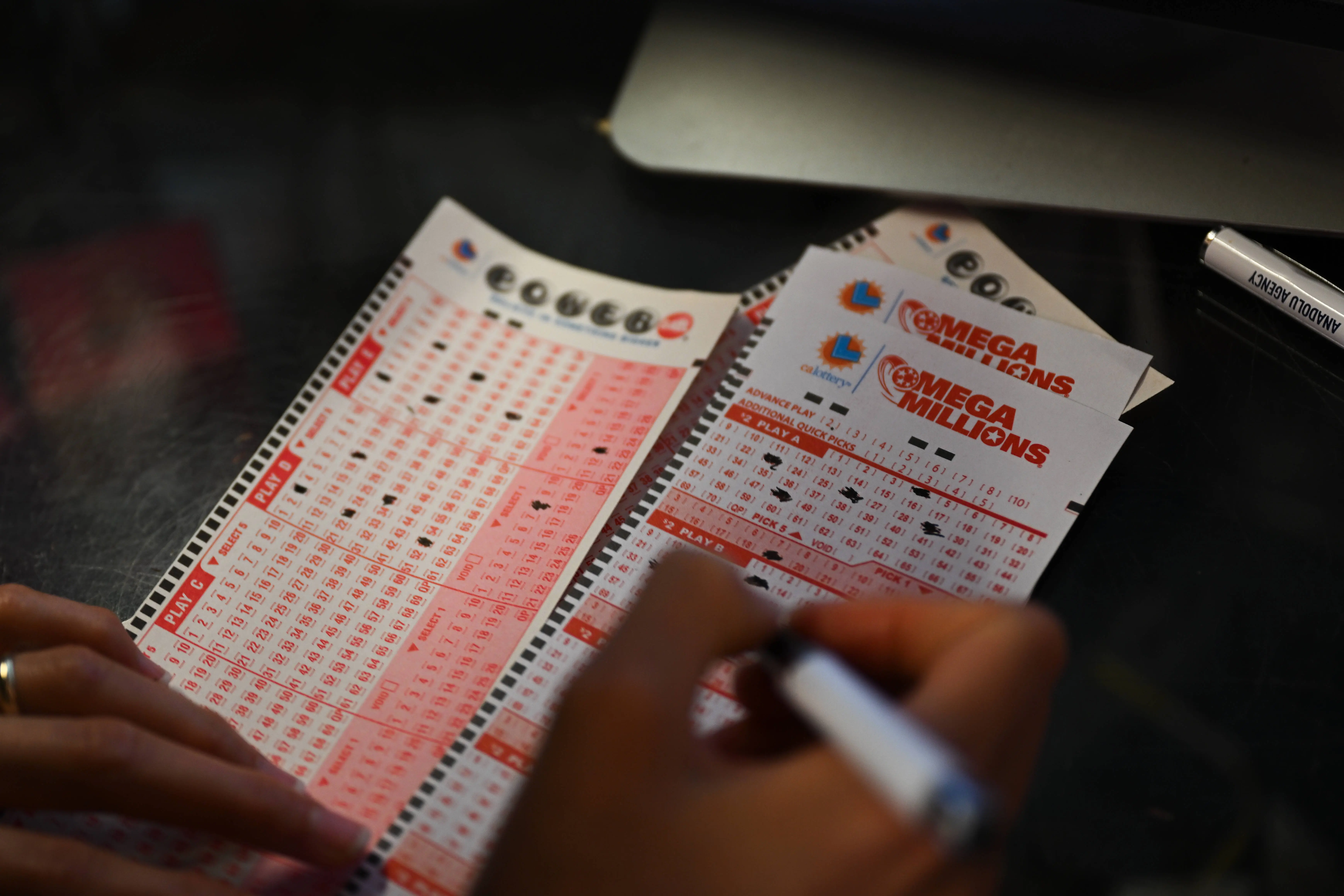 CALIFORNIA, USA - JULY 18: A person plays lottery at a store as US Powerball jackpot grand prize grew to a whopping $1 billion after no ticket got all six numbers in San Mateo, California, United States on July 18, 2023. (Photo by Tayfun Coskun/Anadolu Agency via Getty Images)