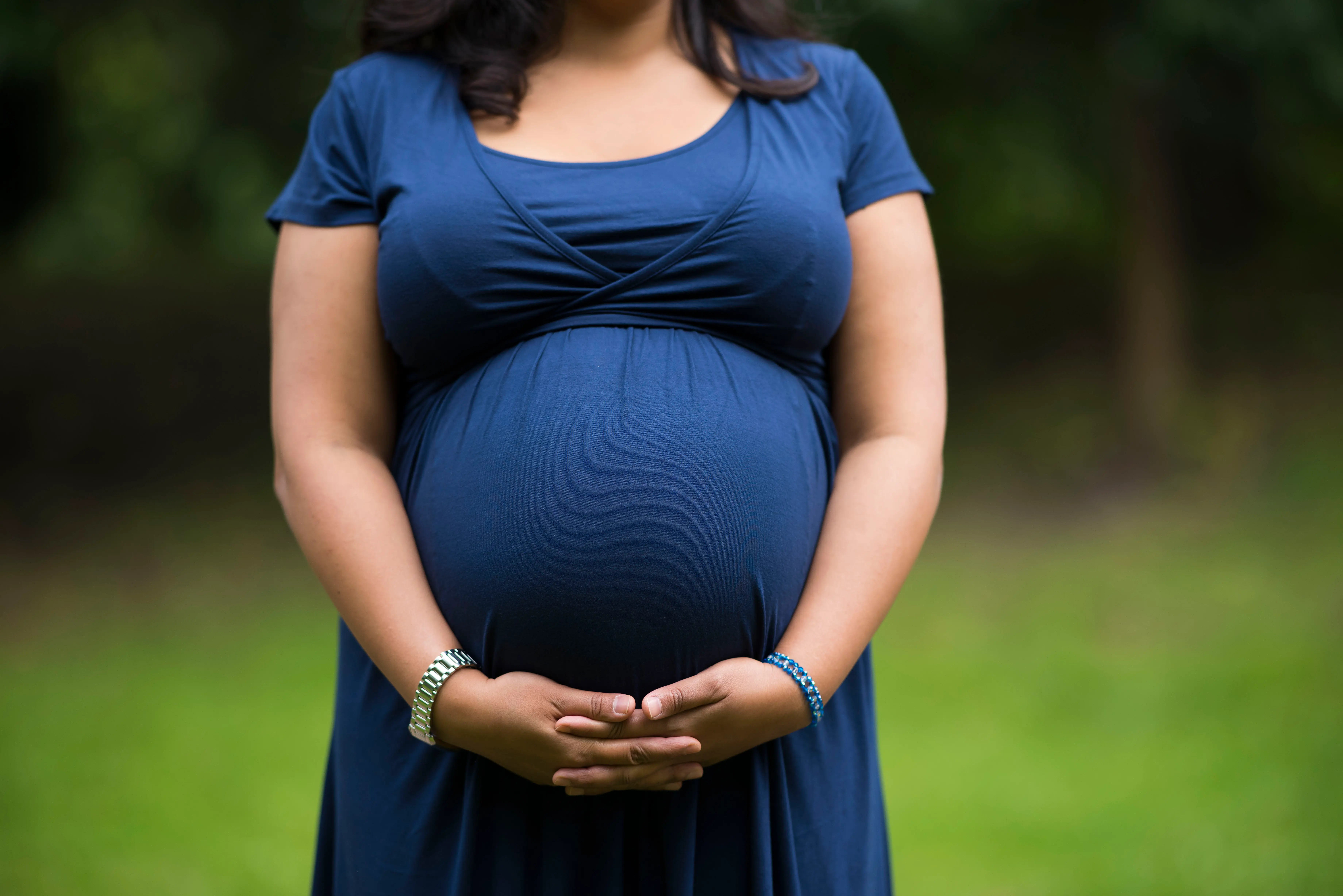CARDIFF, UNITED KINGDOM - SEPTEMBER 27: A pregnant woman holds her belly on September 27, 2016 in Cardiff, United Kingdom. (Photo by Matthew Horwood/Getty Images)