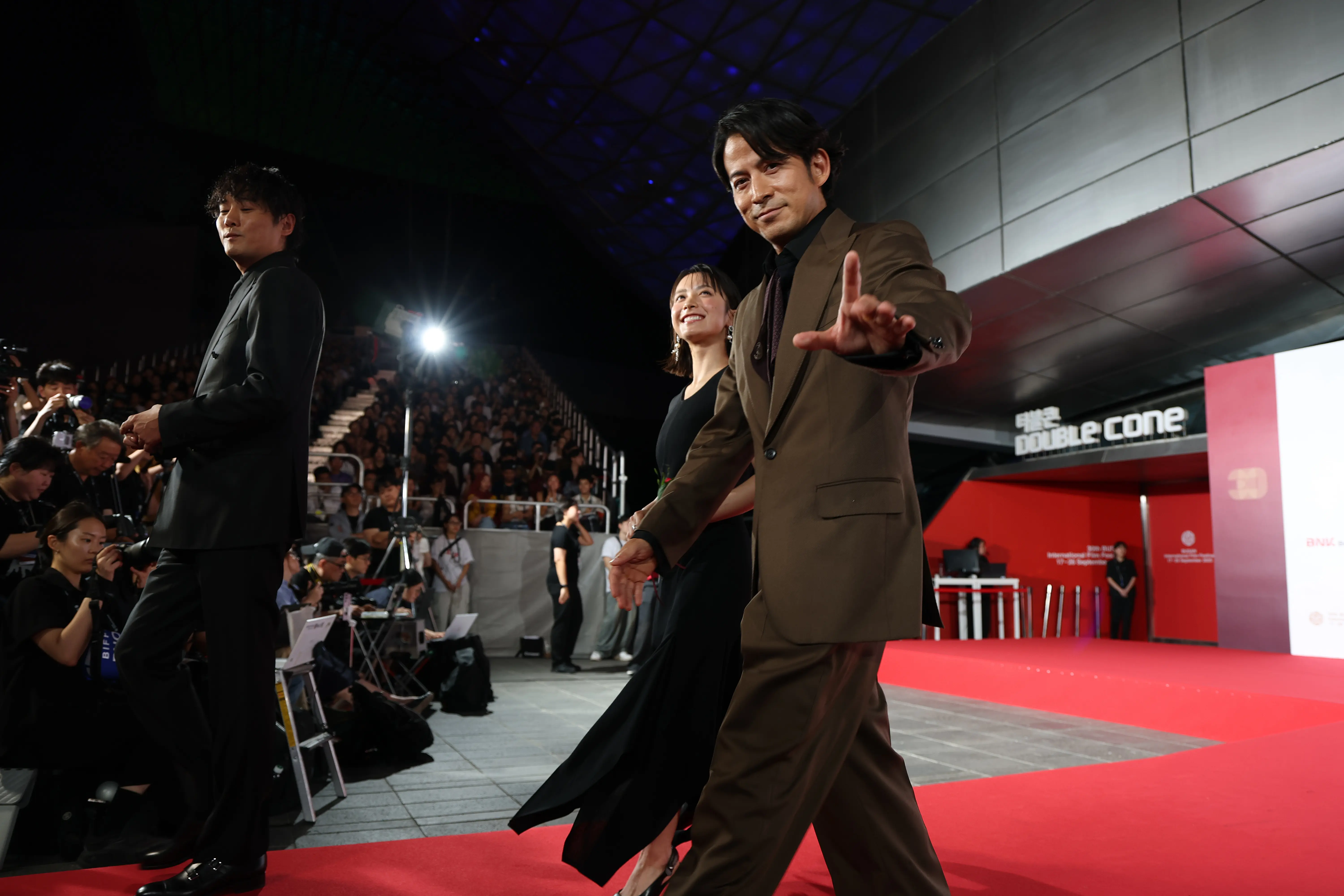 BUSAN, SOUTH KOREA - SEPTEMBER 17: Junichi Okada, Yumia Fujisaki and Michihito Fujii of Netflix's series “Last Samurai Standing” attend the opening ceremony during the 30th Busan International Film Festival at the Busan Cinema Center on September 17, 2025 in Busan, South Korea. (Photo by Chung Sung-Jun/Getty Images)