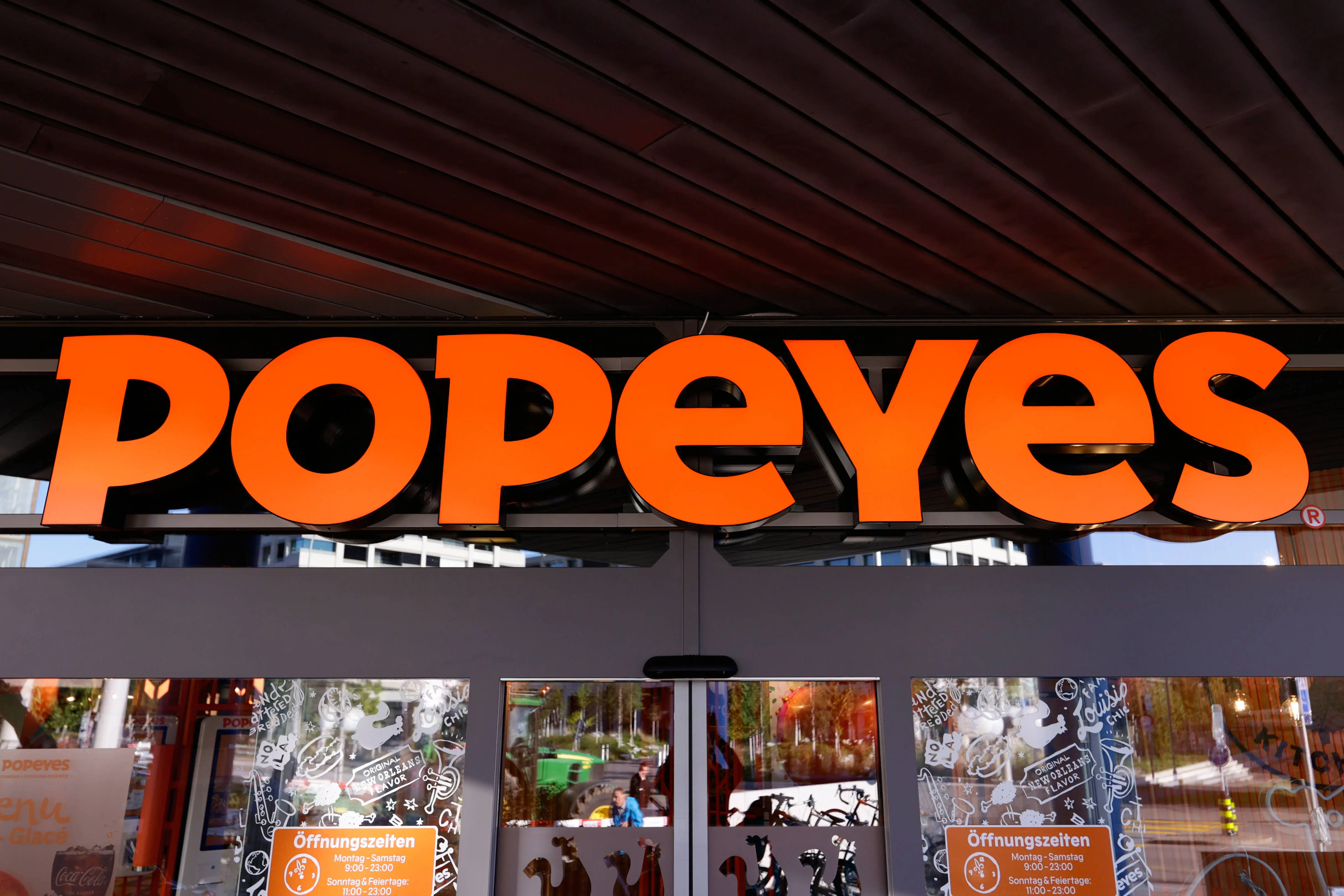 ZRICH, SWITZERLAND - NOVEMBER 13: The Popeyes Louisiana Kitchen Inc logo, also known as Popeyes, the American multinational chain of fried chicken fast food restaurants formed in New Orleans and headquartered in Miami, captured on its Letzipark restaurant on November 13, 2023, in Zrich, Switzerland. (Photo by Joan Cros/NurPhoto via Getty Images)