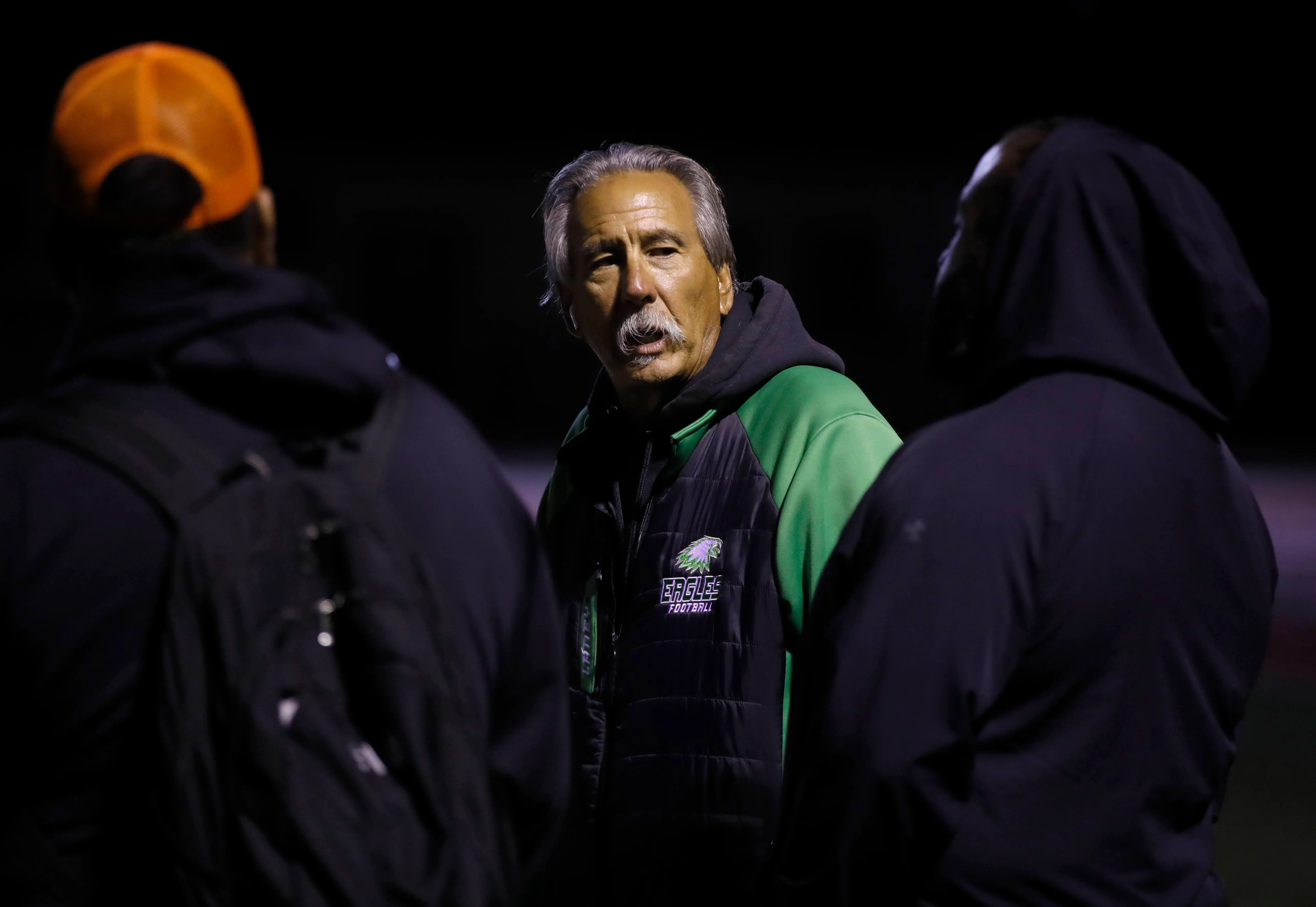 OAKLAND, CALIFORNIA - OCTORBER 21: Laney College football coach John Beam, center, talks with people on the sideline as Oakland Tech plays Skyline High at Skyline High School in Oakland, Calif., on Monday, Oct. 21, 2024. Beam will be retiring this year after nearly five decades of coaching. (Jane Tyska/Digital First Media/East Bay Times via Getty Images)