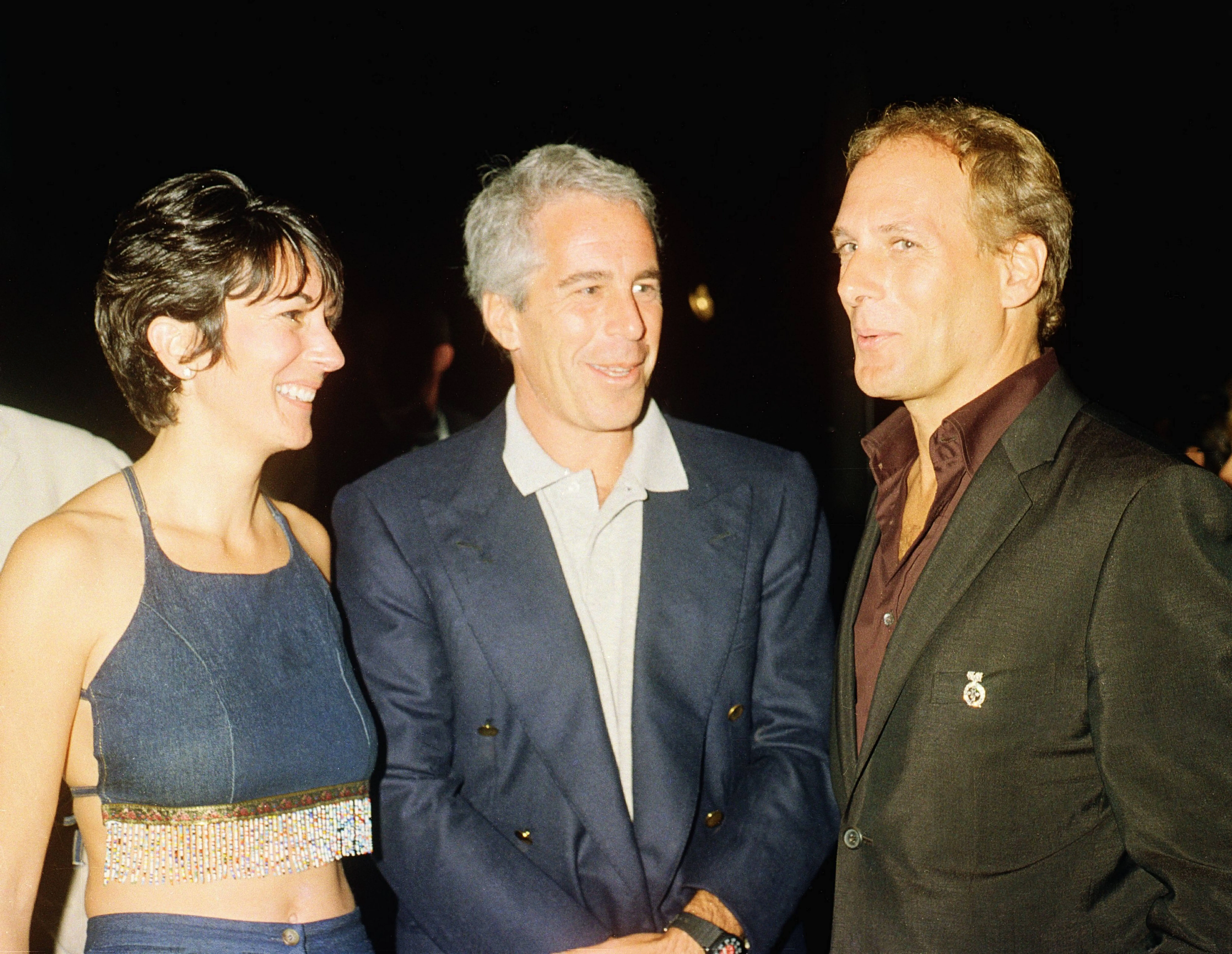 (L-R) Ghislaine Maxwell, Jeffrey Epstein, and musician Michael Bolton pose for a portrait during a party at the Mar-a-Lago club, Palm Beach, Florida, February 12, 2000. (Photo by Davidoff Studios/Getty Images)