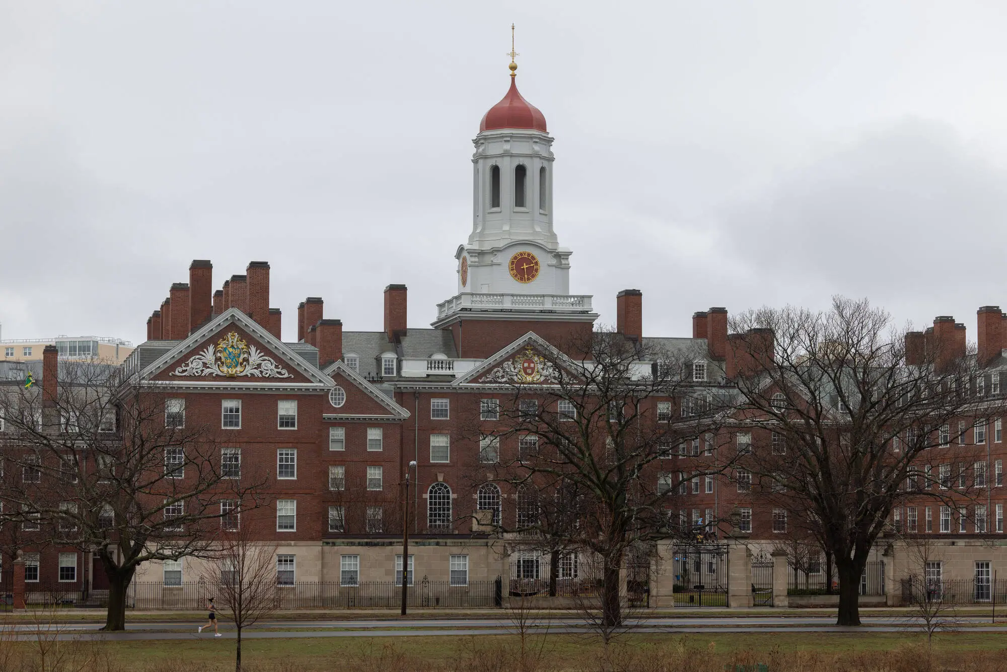 CAMBRIDGE, MASSACHUSETTS - MARCH 17: A person runs past Dunster House at Harvard University on March 17, 2025 in Cambridge, Massachusetts. Harvard University announced free tuition for students from families that make under $200K a year. (Photo by Scott Eisen/Getty Images)