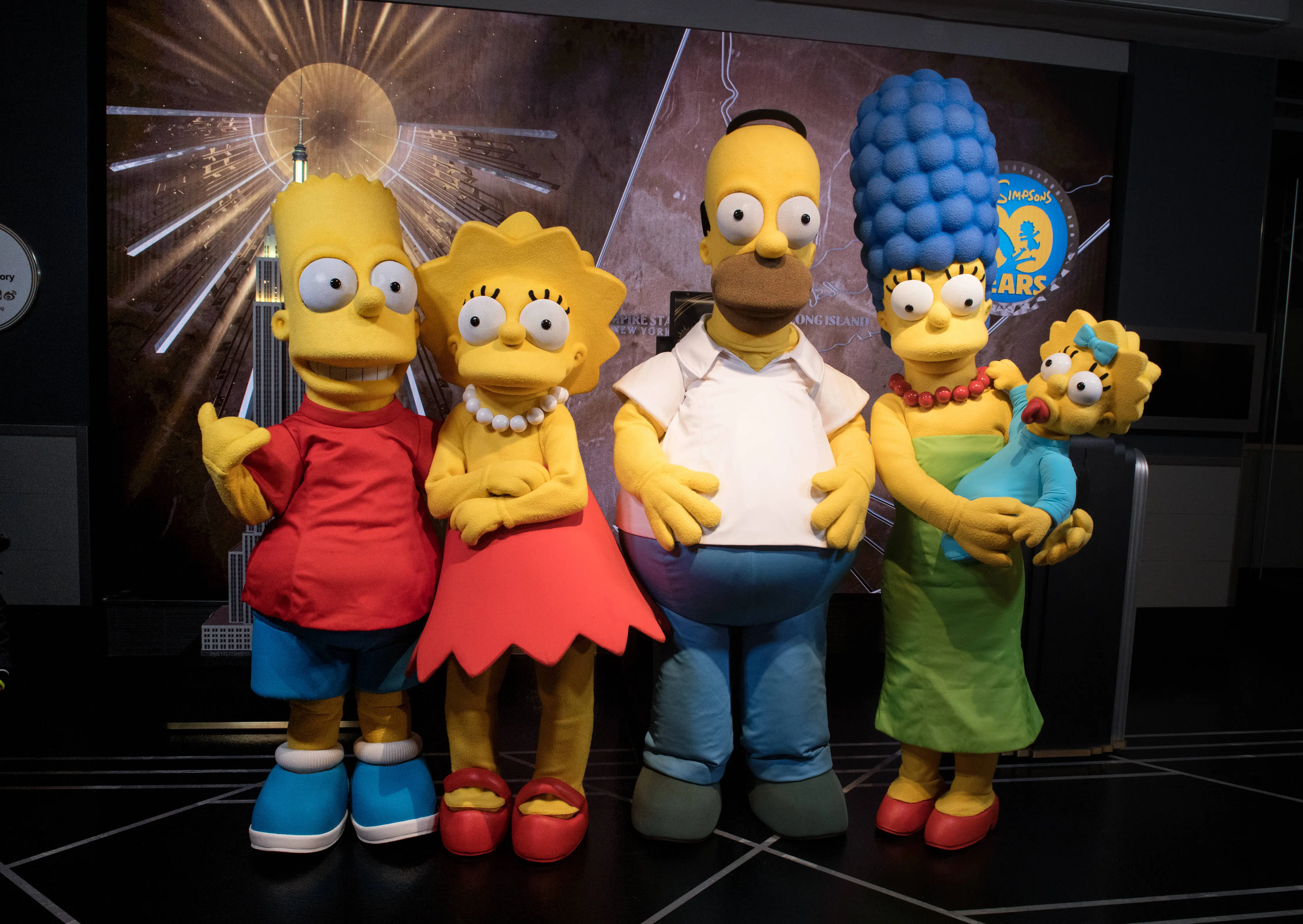 NEW YORK, NY - DECEMBER 17:  (L-R) Bart Simpson, Lisa Simpson, Homer Simpson, Marge Simpson and Maggie Simpson visit The Empire State Building to celebrate the 30th anniversary of "The Simpsons" at The Empire State Building on December 17, 2018 in New York City.  (Photo by Noam Galai/Getty Images)