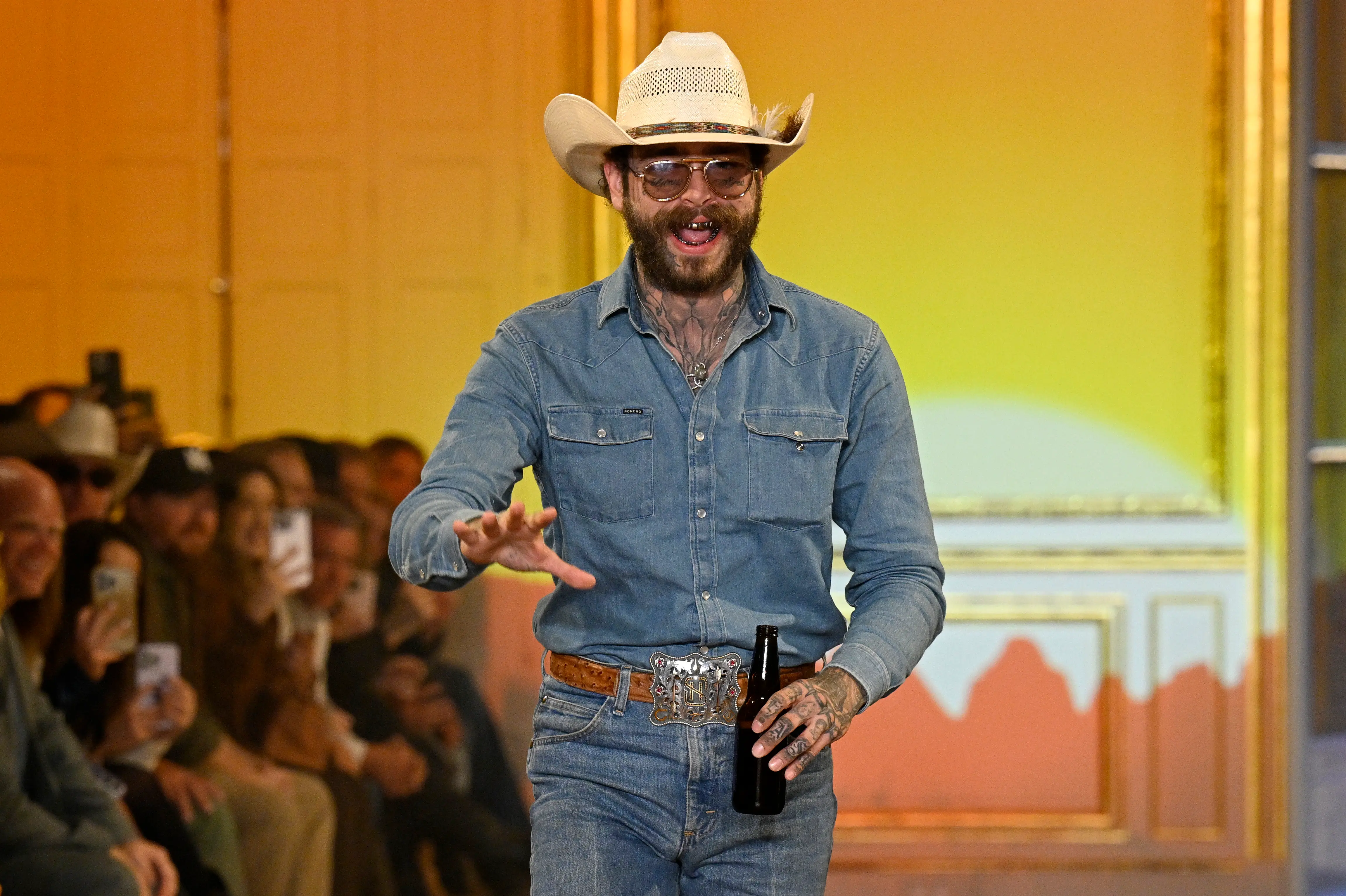 PARIS, FRANCE - SEPTEMBER 01: Post Malone acknowledges the audience during the Austin Post Runway Show on September 01, 2025 in Paris, France. (Photo by Kristy Sparow/Getty Images)