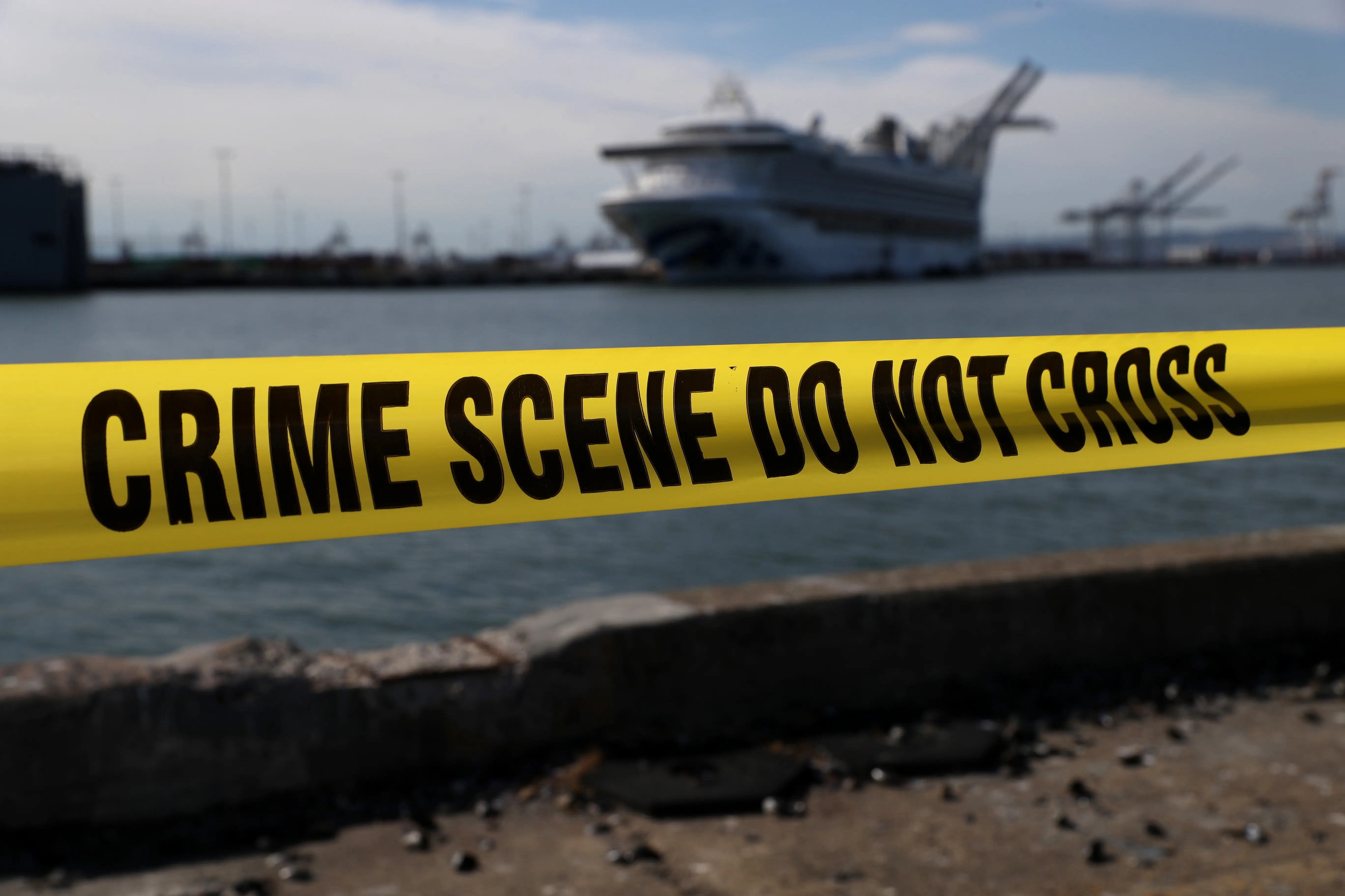 OAKLAND, CALIFORNIA - MARCH 10: Crime scene tape marks off the area where members of the media are staging near the Princess Cruises Grand Princess cruise ship as it sits docked in the Port of Oakland on March 10, 2020 in Oakland, California. Passengers are slowly disembarking from the Princess Cruises Grand Princess a day after it docked at the Port of Oakland. The ship was held off the coast of California after 21 people on board tested tested positive for COVID-19 also known as the Coronavirus. (Photo by Justin Sullivan/Getty Images)