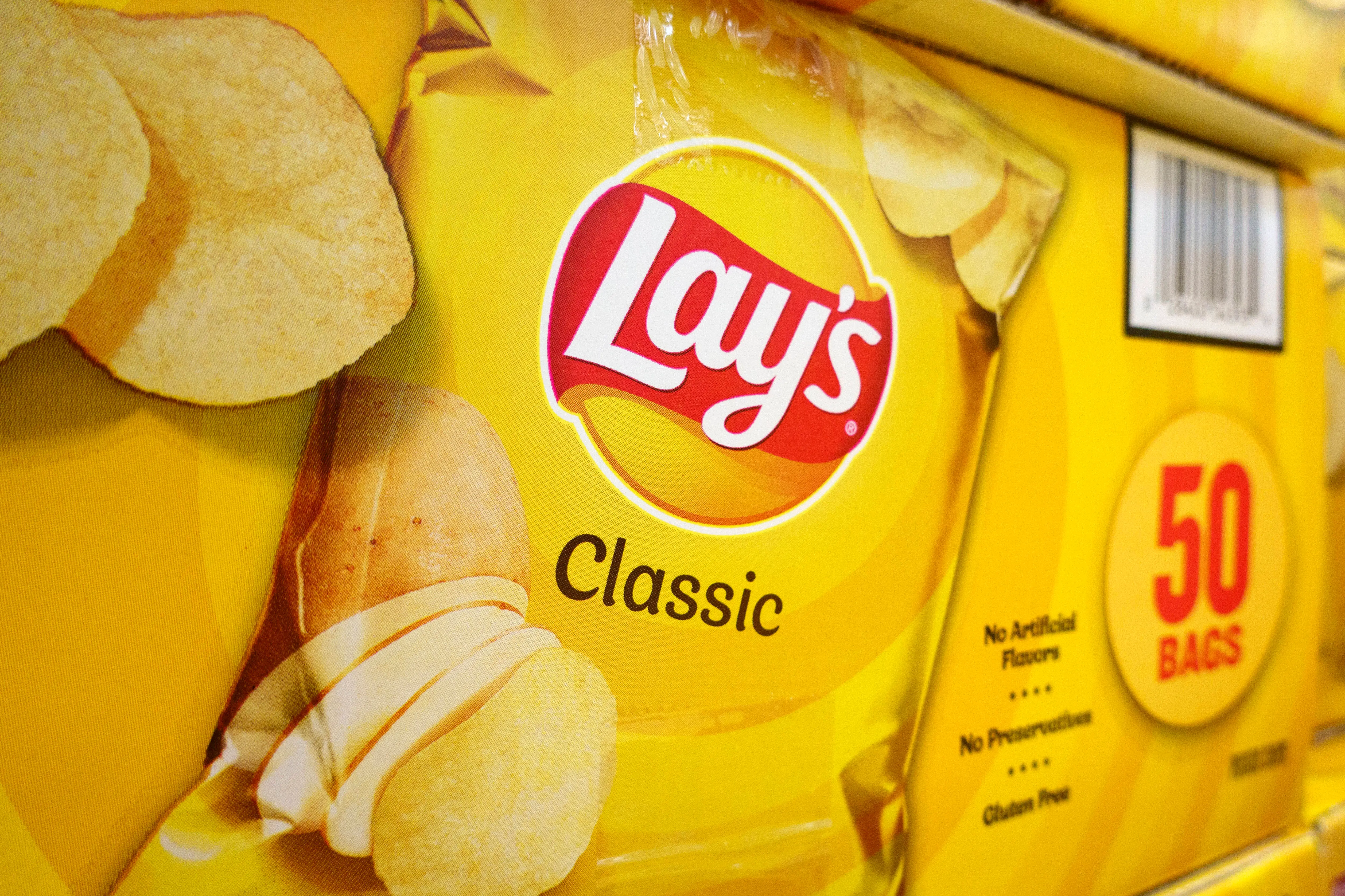 SAN DIEGO, CALIFORNIA - JULY 12: Boxes of Lay's classic potato chips are displayed at a Costco Wholesale store on July 12, 2025 in San Diego, California. (Photo by Kevin Carter/Getty Images)
