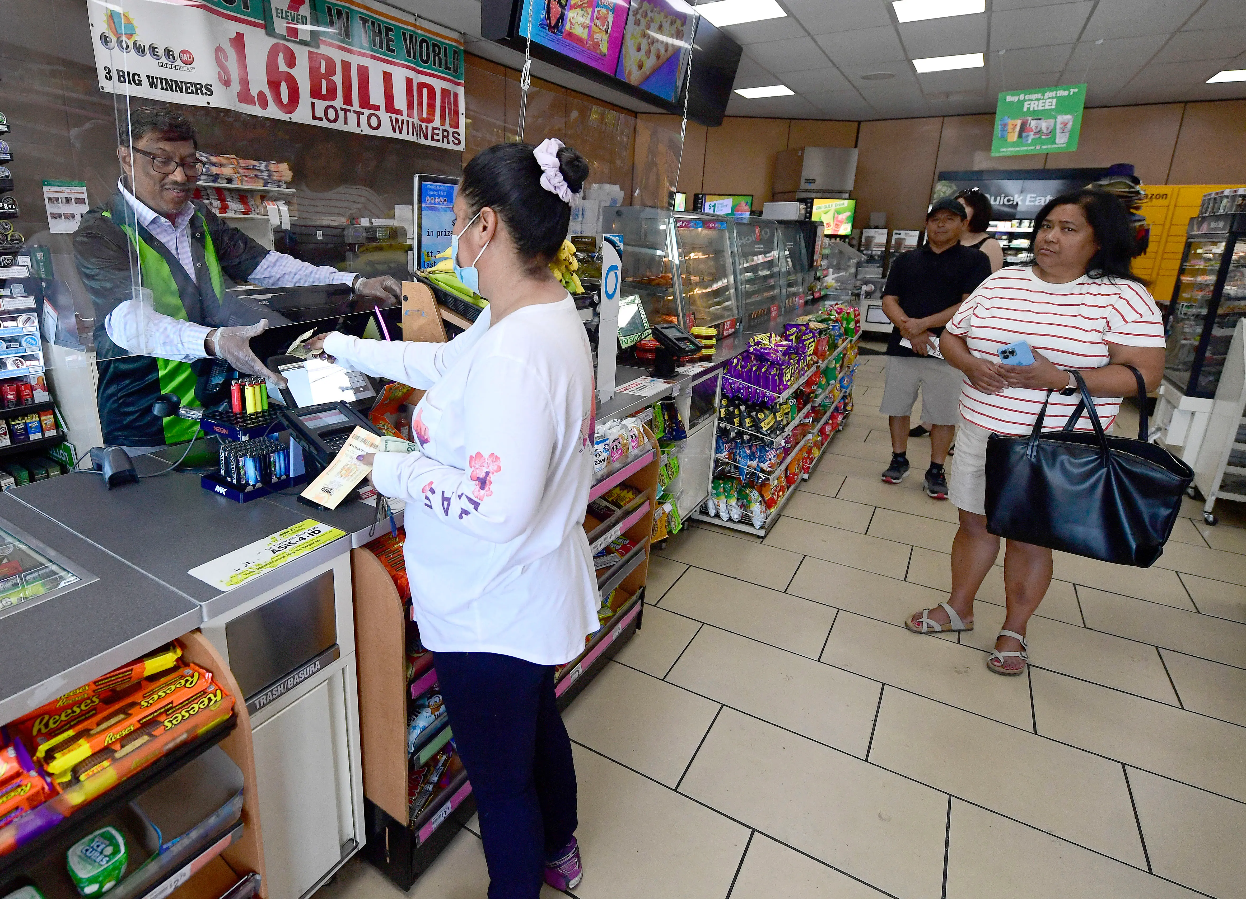 Chino Hills, CA - July 27: Customers line up to purchase Mega Millions tickets from 7-Eleven assistant manager M. Faroqui in Chino Hills on Wednesday, July 27, 2022 where Fridays Mega Millions payout is expected to exceed $1 billion. Faroqui sold one of three winning Powerball tickets worth over $528 million each back in 2016 when the jackpot reached over $1.5 billion. (Photo by Will Lester/MediaNews Group/Inland Valley Daily Bulletin via Getty Images)