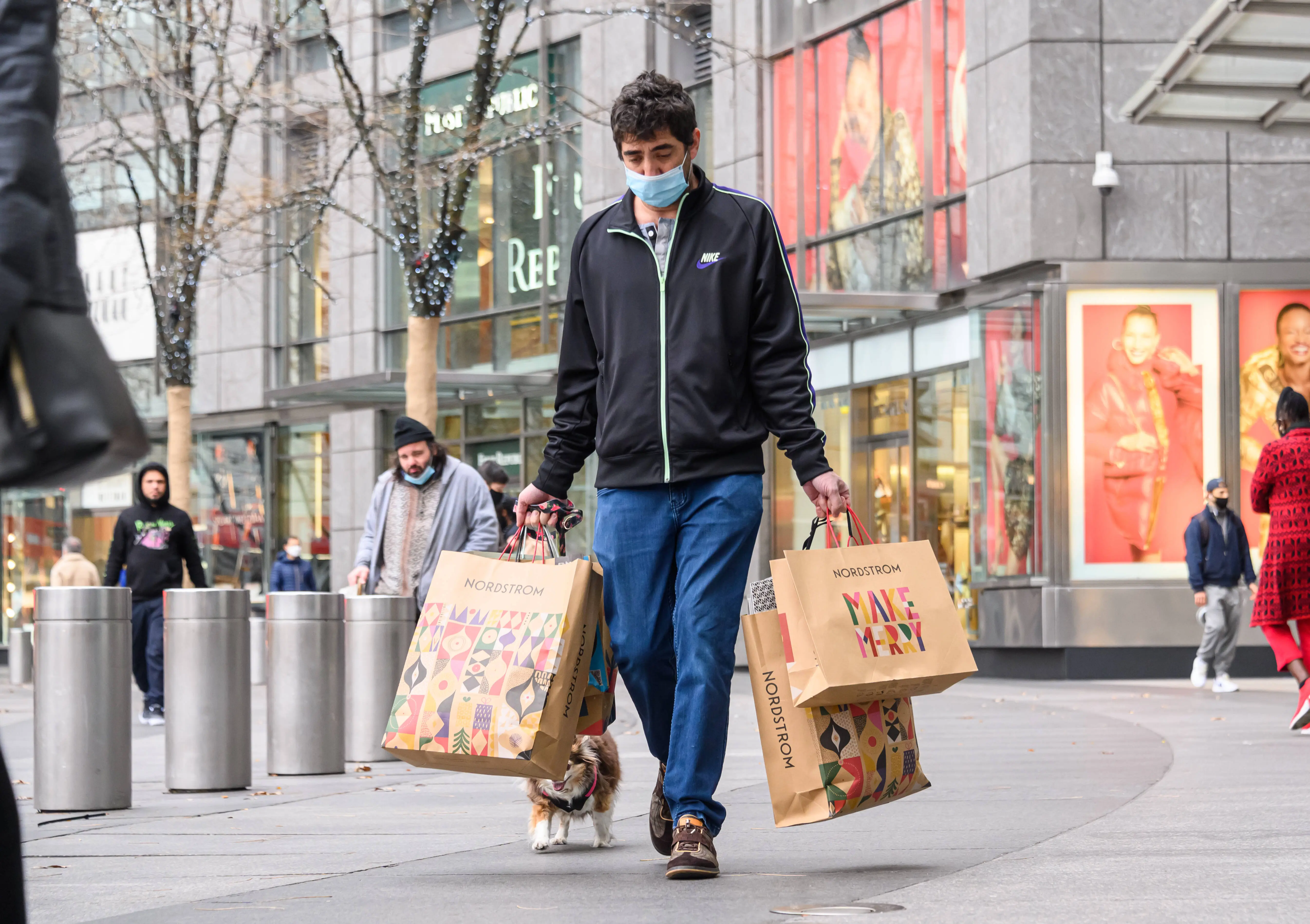 NEW YORK, NEW YORK - NOVEMBER 28: A person wears a face mask while carrying shopping bags in Columbus Circle on November 28, 2020 in New York City. (Photo by Noam Galai/Getty Images)
