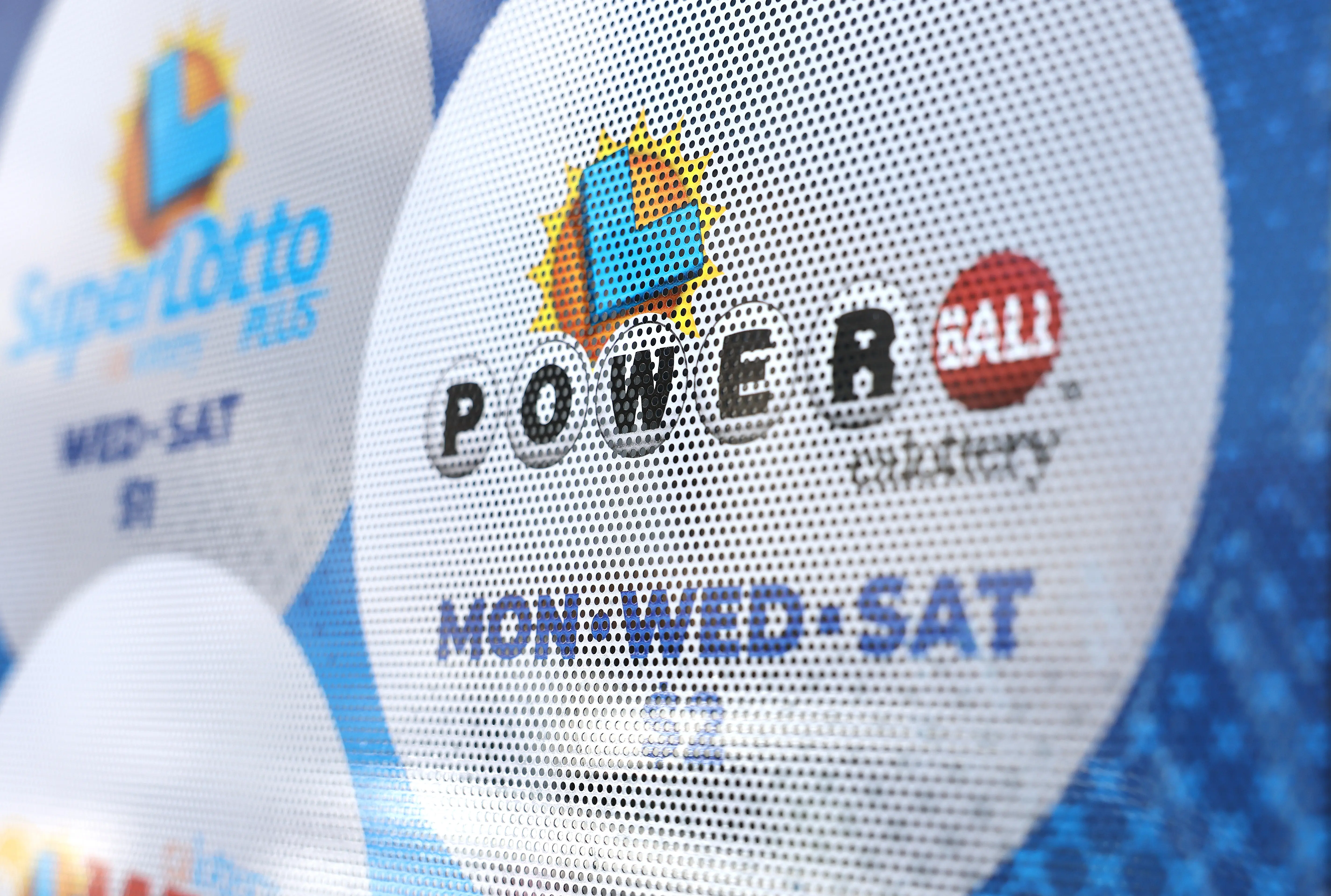 LOS ANGELES, CALIFORNIA - JULY 18: A California Lottery poster advertises Powerball and other lotteries at a convenience store on July 18, 2023 in Los Angeles, California. The Powerball jackpot for the drawing on July 19th is now estimated to be $1 billion after three months of drawings without a winner. (Photo by Mario Tama/Getty Images)