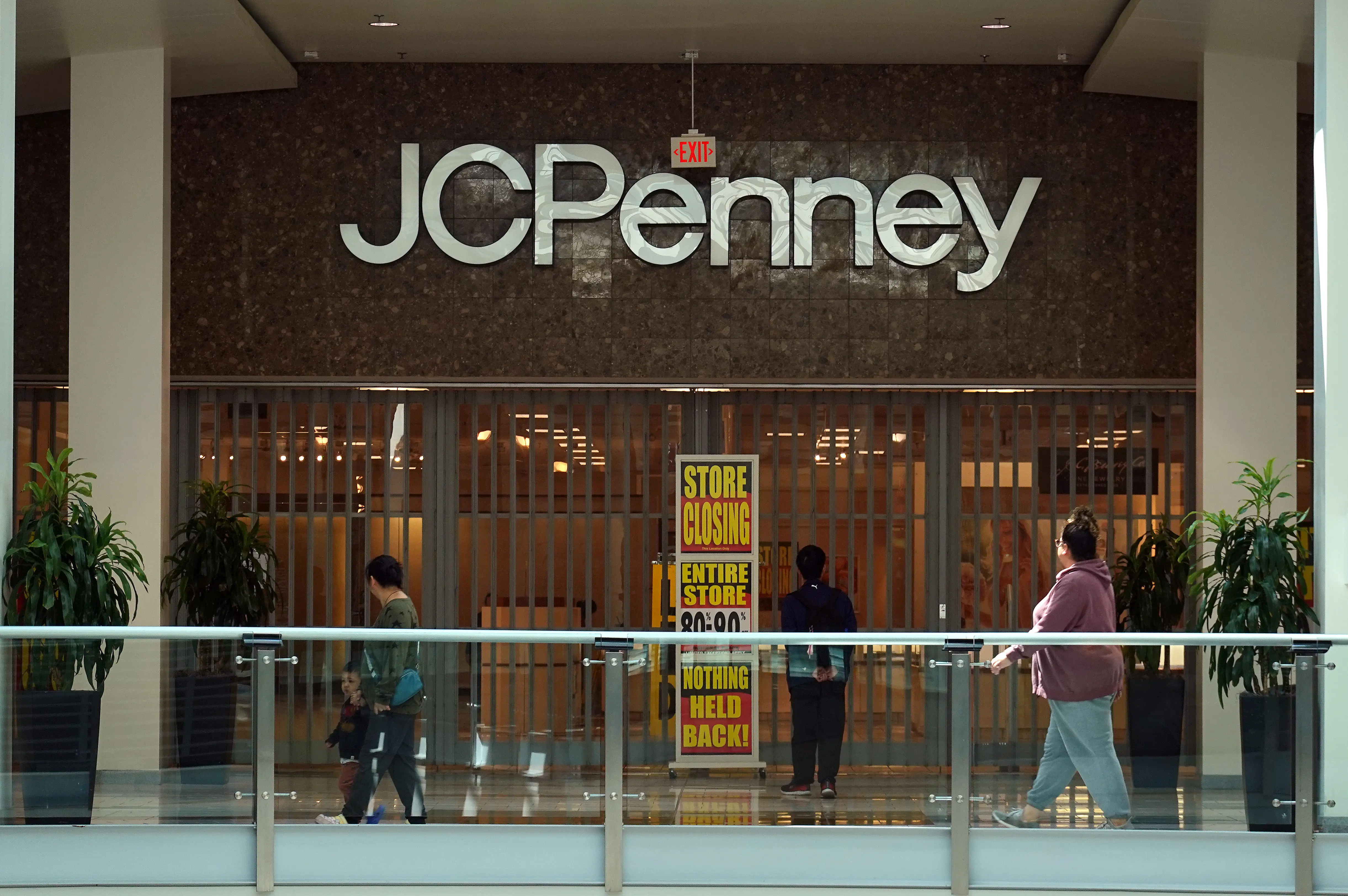 SAN BRUNO, CALIFORNIA - MAY 22: People walk by a JCPenney store that is set to close on May 22, 2025 in San Francisco, California. Retailer JCPenney will permanently close seven of its stores across the United States on Sunday, May 25, as the company continues to restructure after filing for bankruptcy in 2020. (Photo by Justin Sullivan/Getty Images)