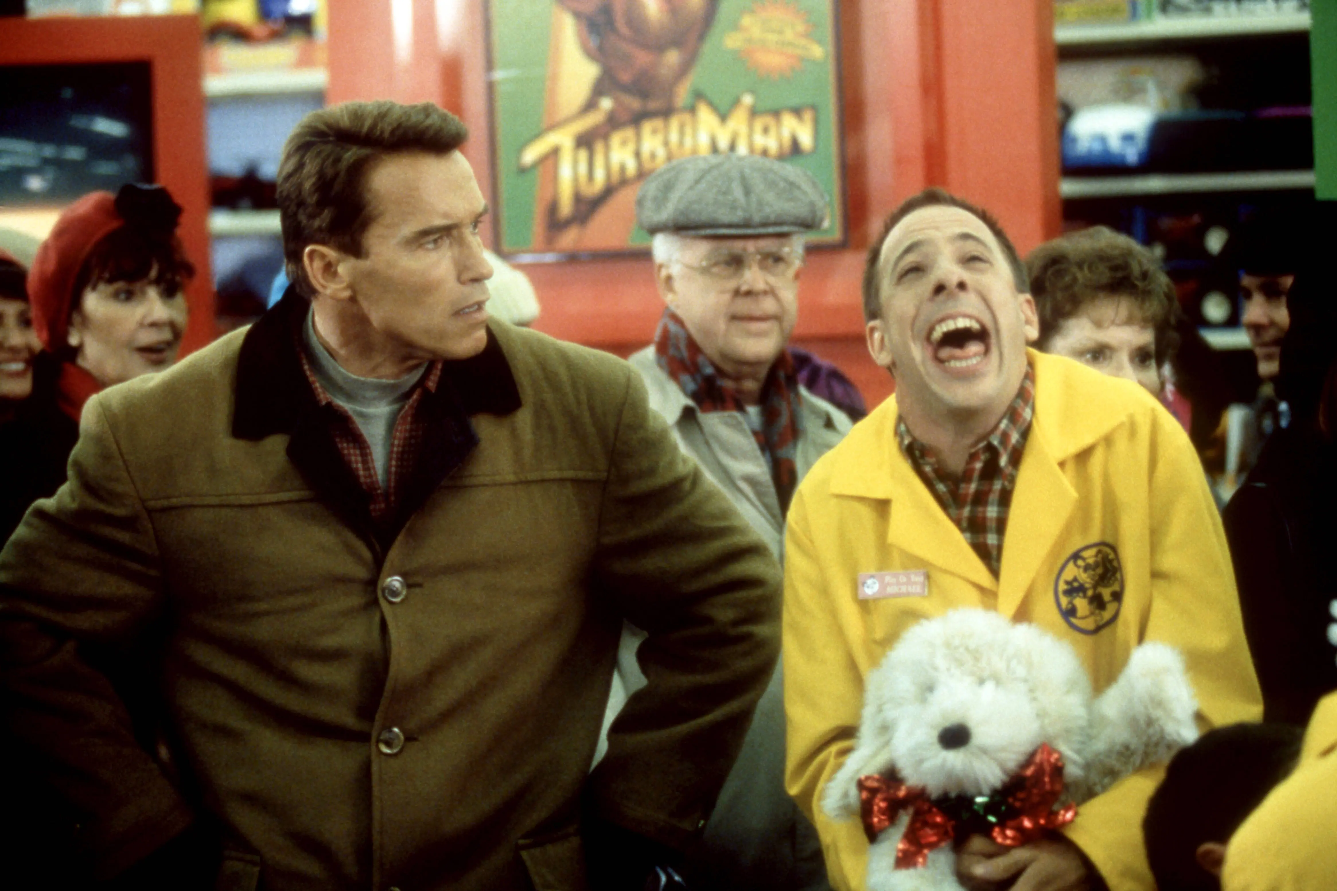 (L-R) Austrian and American actor Arnold Schwarzenegger and American actor Patrick Richwood film a scene during the 1996 comedy movie 'Jingle All the Way' in New York, New York, circa 1996. (Photo by Oscar Abolafia/TPLP/Getty Images)