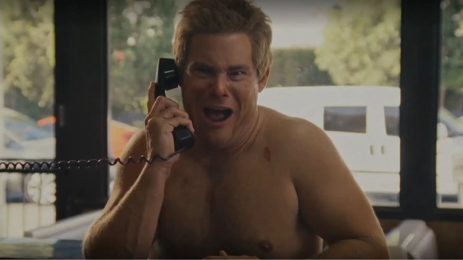 Adam DeVine as Chad Korn panics on the security call inside Little Caesars in It’s Florida, Man. season 2 episode 2. (Image via HBO Max))