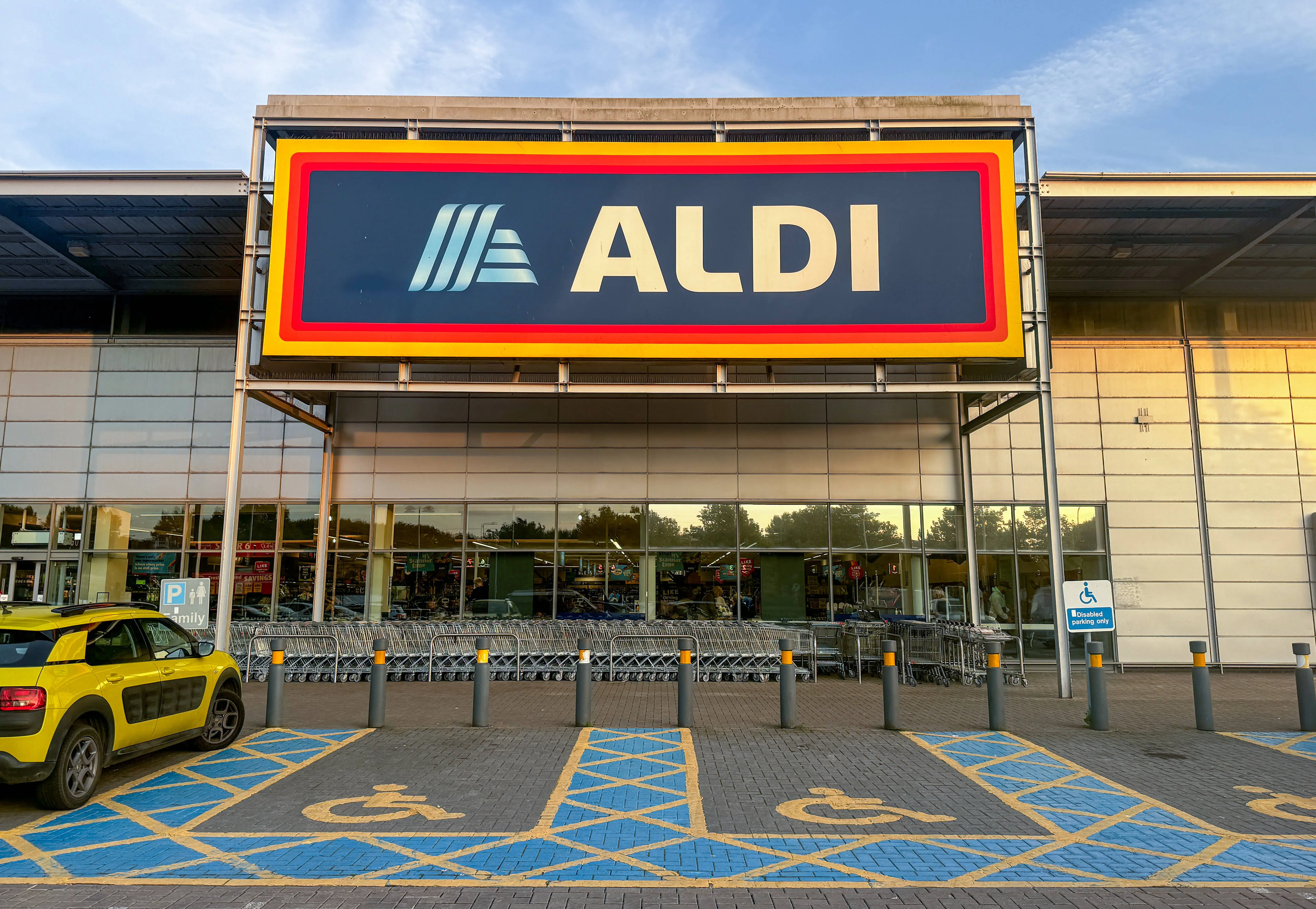 WESTON-SUPER-MARE, UNITED KINGDOM - SEPTEMBER 14: Shoppers enter a branch of the budget supermarket retailer Aldi on September 14, 2024 in Weston-super-Mare, England. The German retailer founded in 1946, has been gaining popularity with shoppers of groceries in the UK. (Photo by Matt Cardy/Getty Images)