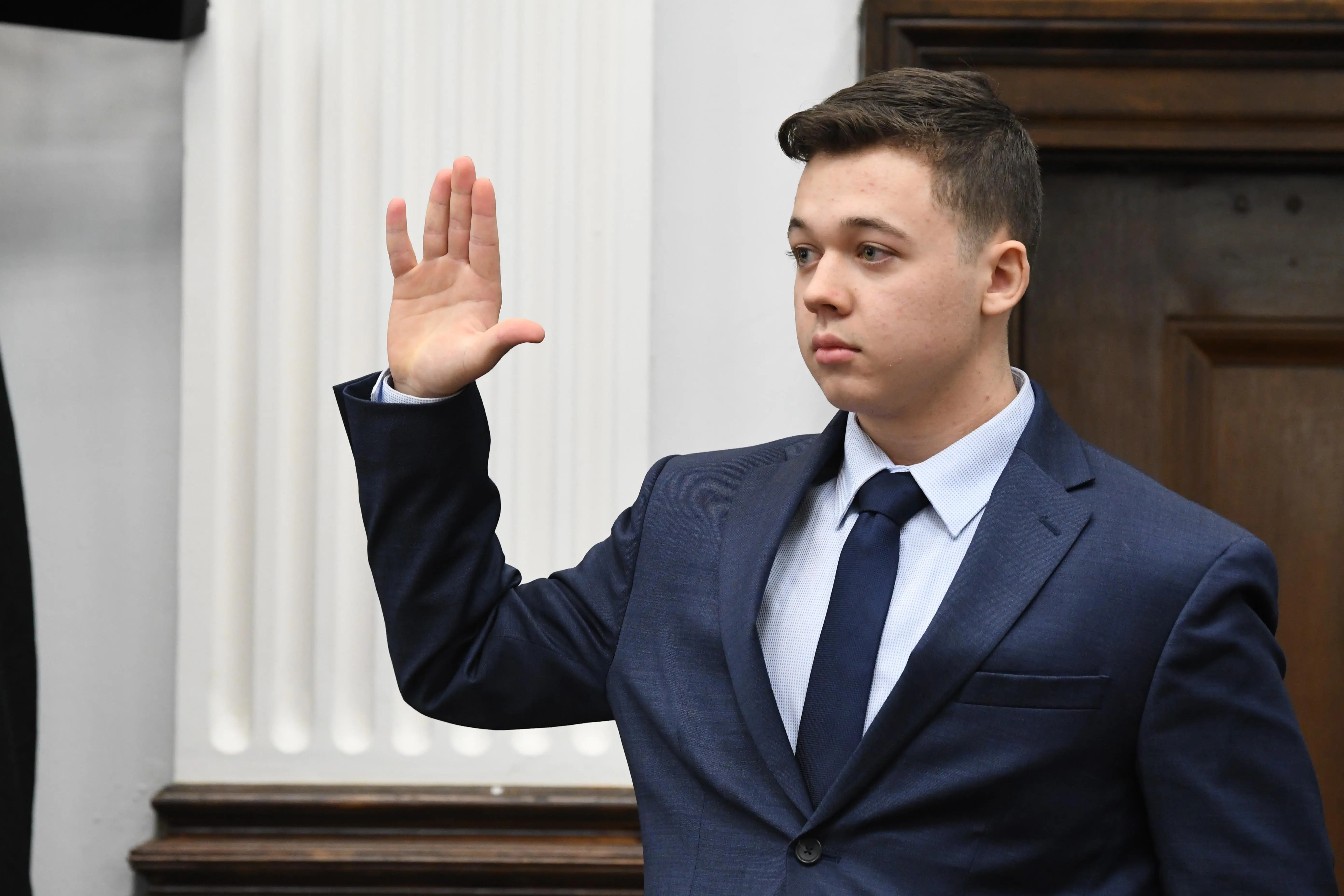 KENOSHA, WISCONSIN - NOVEMBER 10: Kyle Rittenhouse is sworn in to testify during his trial at the Kenosha County Courthouse on November 10, 2021 in Kenosha, Wisconsin. Rittenhouse shot three demonstrators, killing two of them, during a night of unrest that erupted in Kenosha after a police officer shot Jacob Blake seven times in the back while police attempted to arrest him in August 2020. Rittenhouse, from Antioch, Illinois, was 17 at the time of the shooting and armed with an assault rifle. He faces counts of felony homicide and felony attempted homicide. (Photo by Mark Hertzberg-Pool/Getty Images)