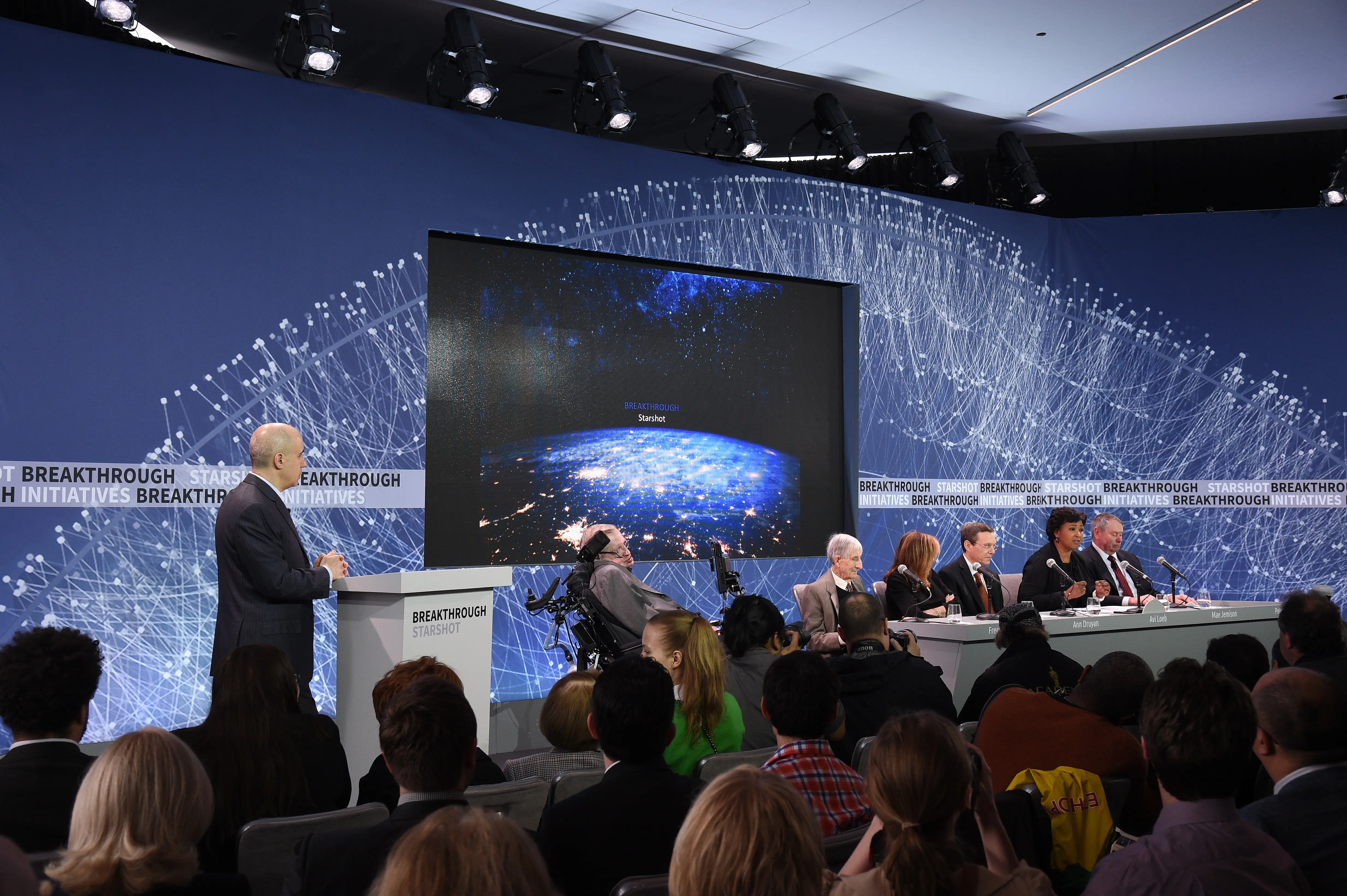 NEW YORK, NEW YORK - APRIL 12:  (L-R) Yuri Milner, Breakthrough Prize and DST Global Founder; Stephen Hawking, CH, CBE, FRS, Dennis Stanton Avery and Sally Tsui Wong-Avery Director of Research, University of Cambridge; Freeman Dyson, Emeritus Professor, Princeton Institute for Advanced Study; Ann Druyan, Producer, Co-Founder and CEO of Cosmos Studios; Avi Loeb, Frank B. Baird, Jr. Professor of Science at Harvard University; Mae Jamison, Nasa Astronaut, Principal 100 Year Starship Foundation; and Peter Worden, Chairman, Breaktrough Prize Foundation, Former NASA Director speak on stage as Yuri Milner And Stephen Hawking host press conference to announce Breakthrough Starshot, a new space exploration initiative, at One World Observatory on April 12, 2016 in New York City.  (Photo by Bryan Bedder/Getty Images for Breakthrough Prize Foundation)